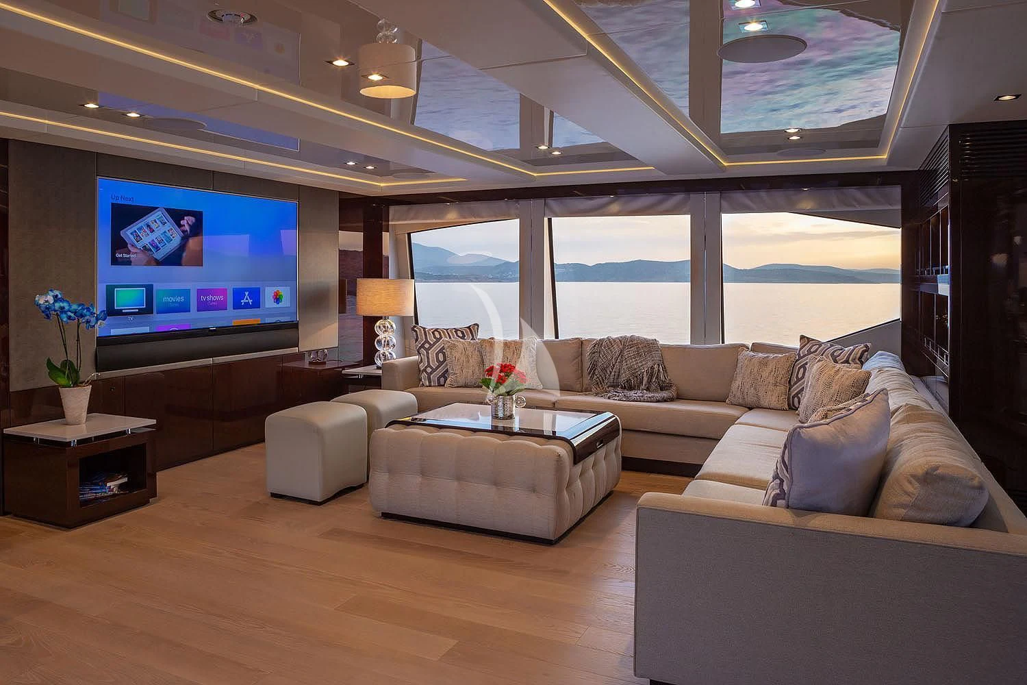 a living room with a large screen aboard AQUA LIBRA Yacht for Charter