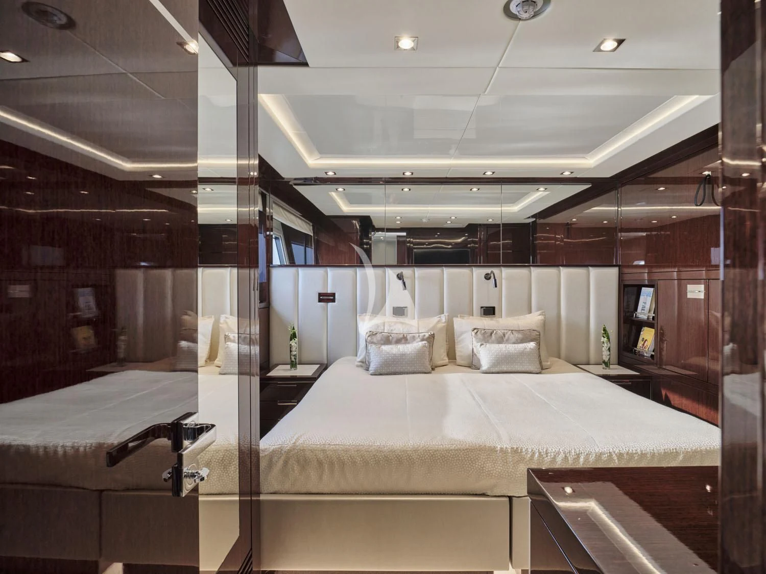a room with beds and a mirror aboard AQUA LIBRA Yacht for Charter