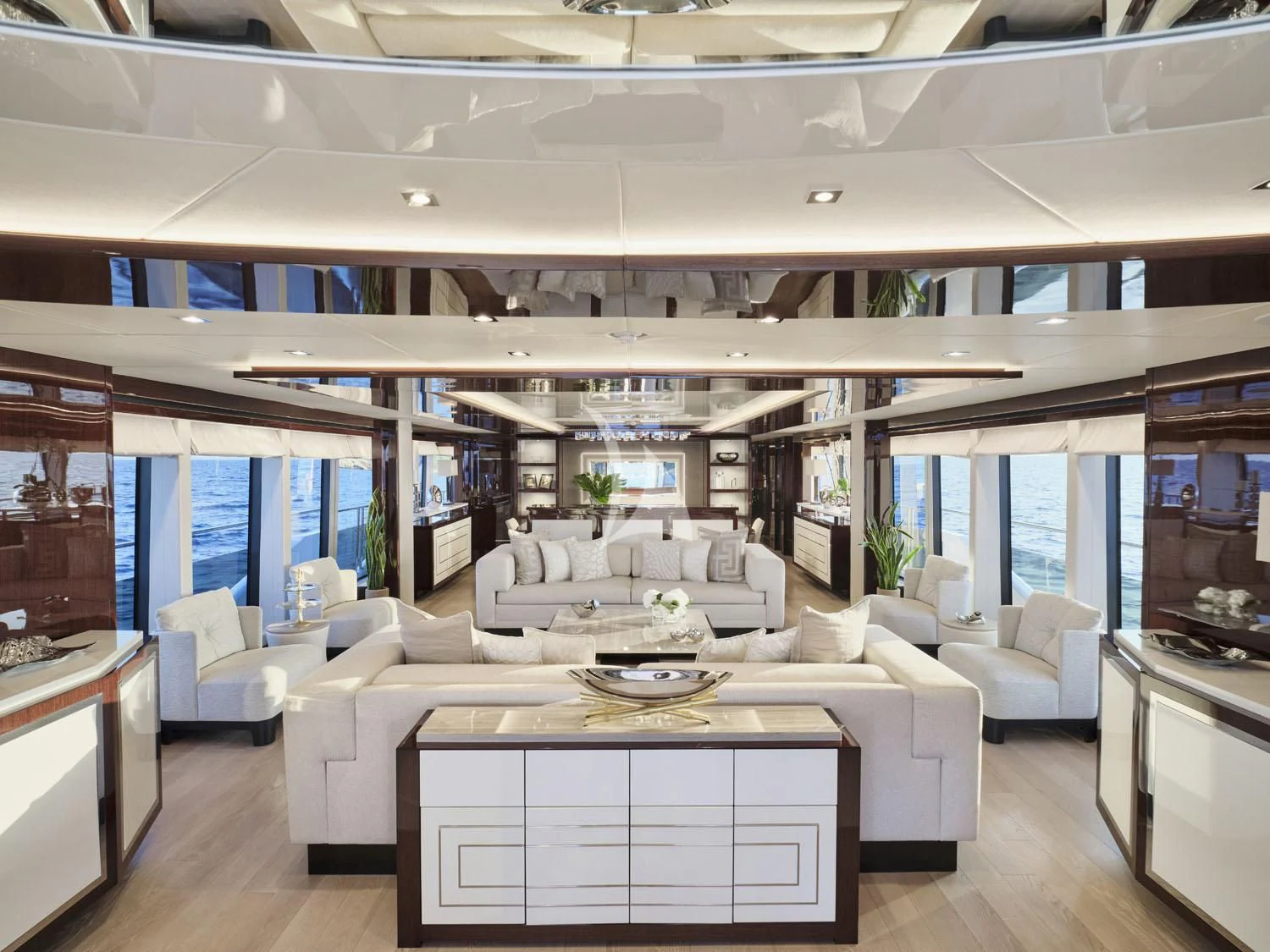 a large living room with white couches and a table aboard AQUA LIBRA Yacht for Charter