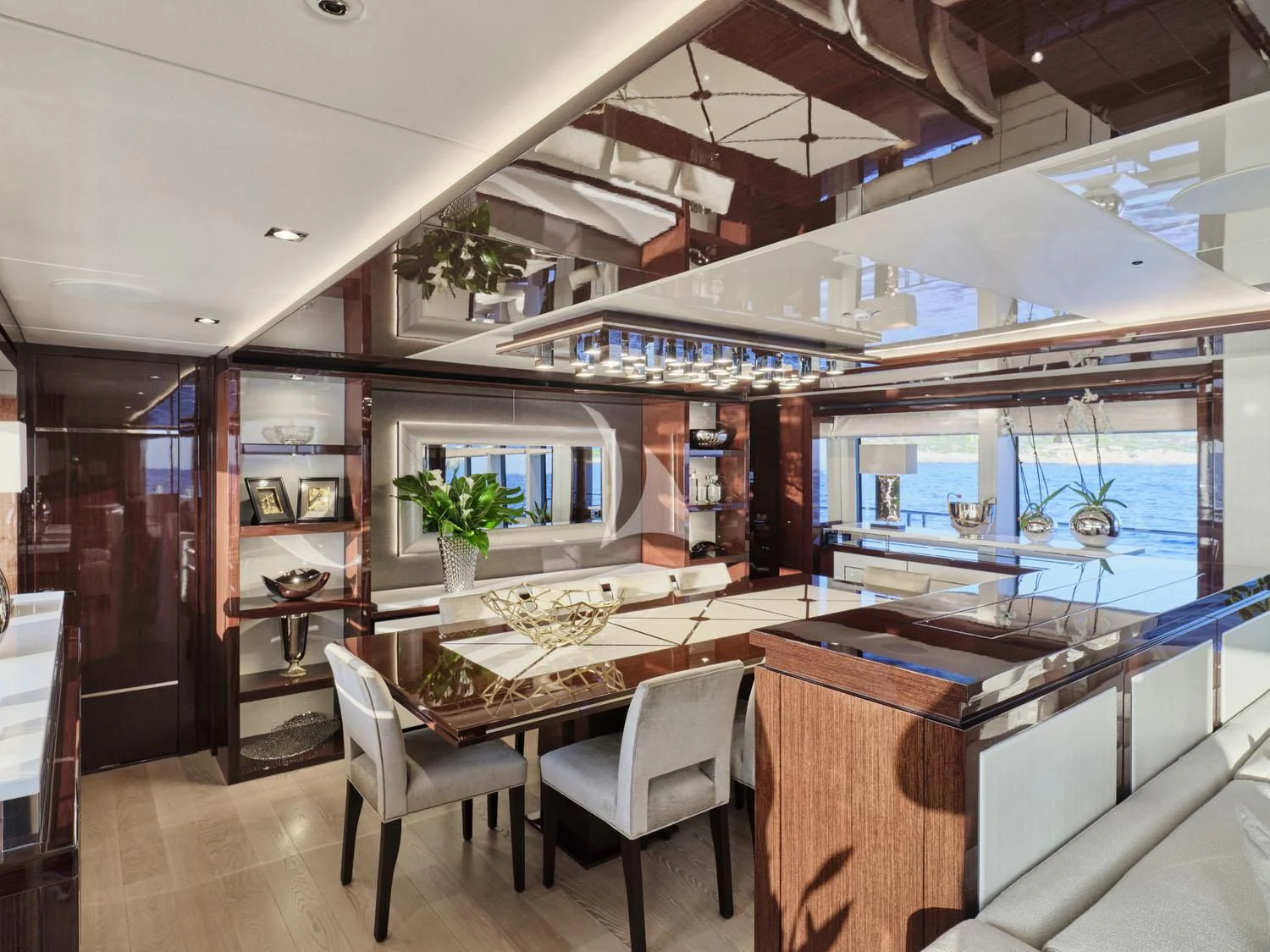 a room with a table chairs and a large window aboard AQUA LIBRA Yacht for Charter