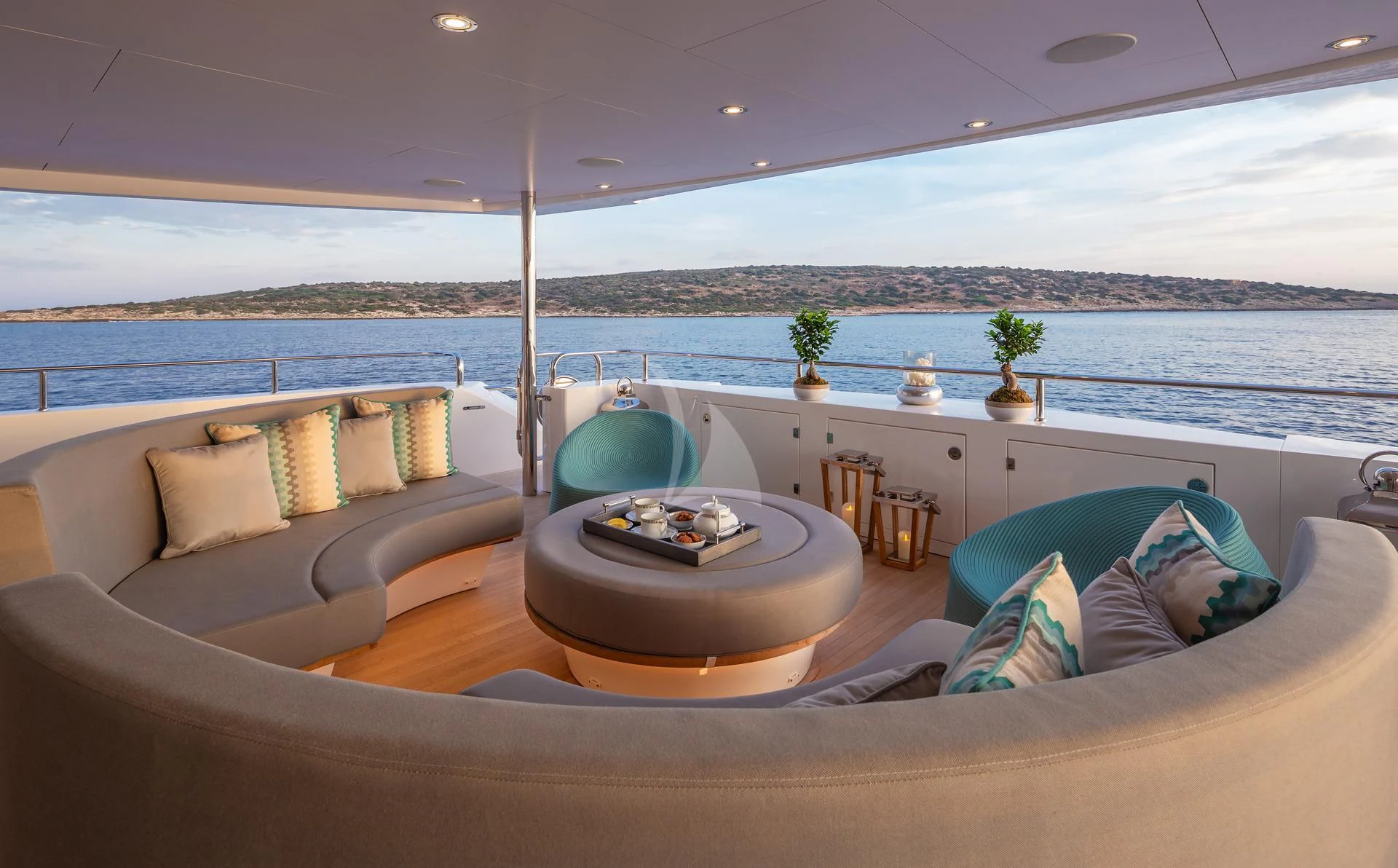 a large living room with a large balcony overlooking the ocean aboard AQUA LIBRA Yacht for Charter