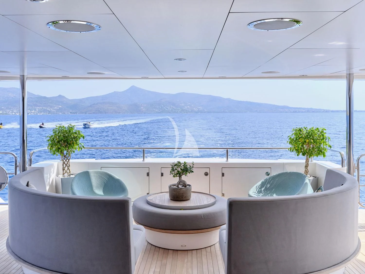 a room with a view of the ocean and mountains aboard AQUA LIBRA Yacht for Charter