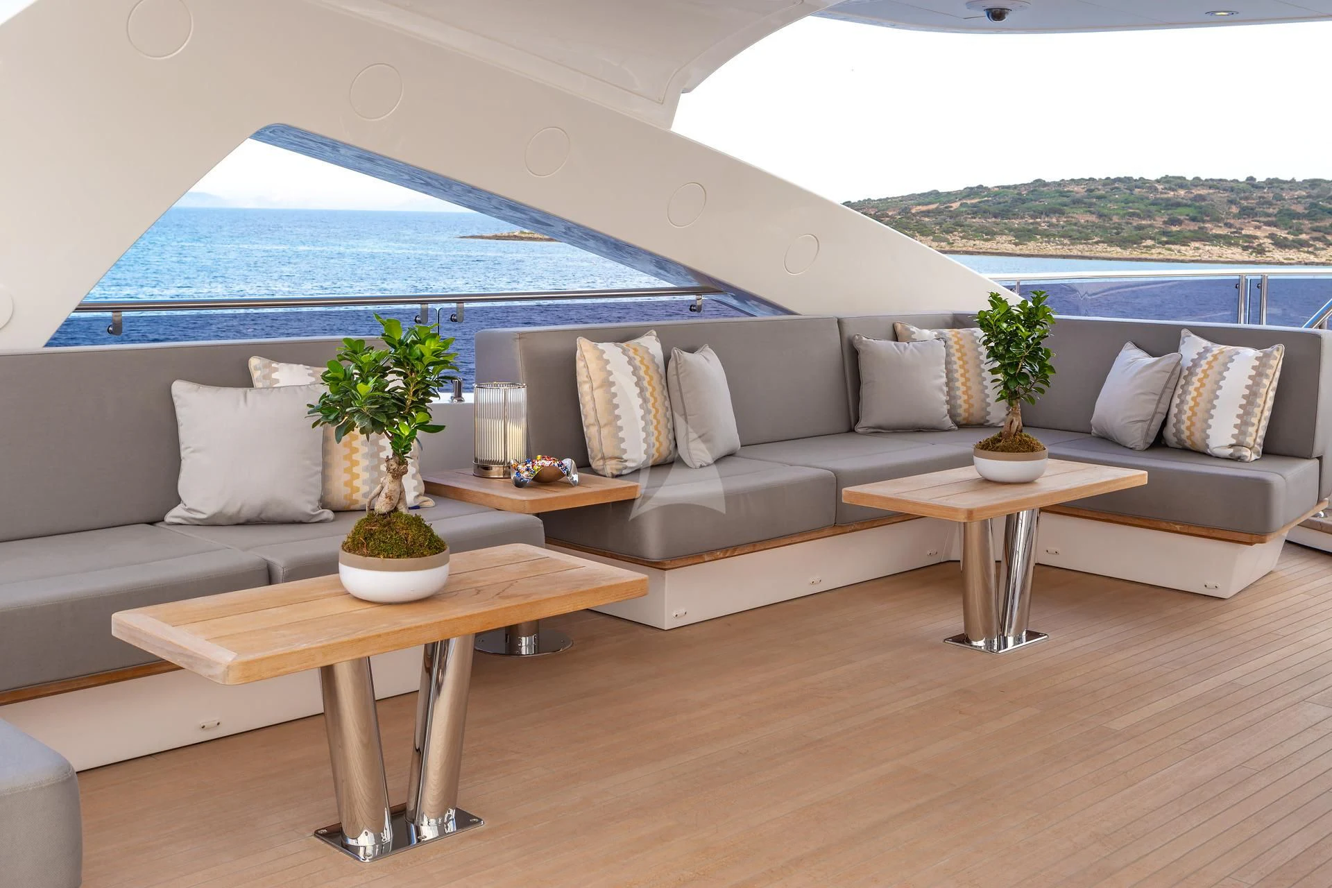 a living room with a large blue and white umbrella aboard AQUA LIBRA Yacht for Charter