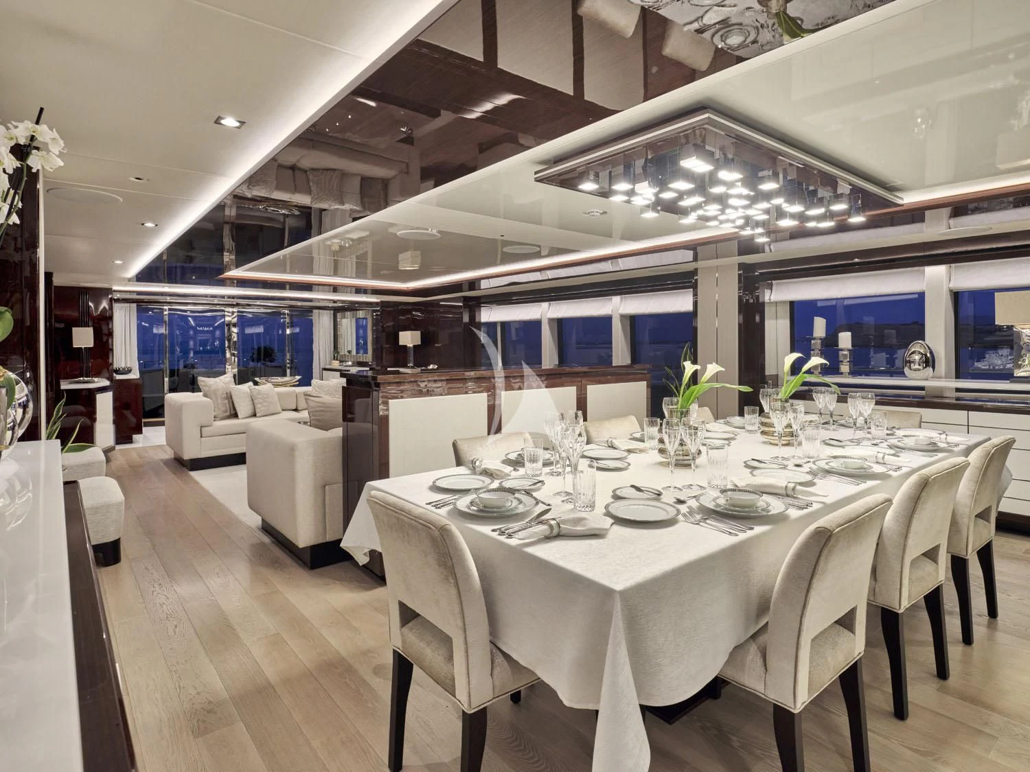 a room with tables and chairs aboard AQUA LIBRA Yacht for Charter