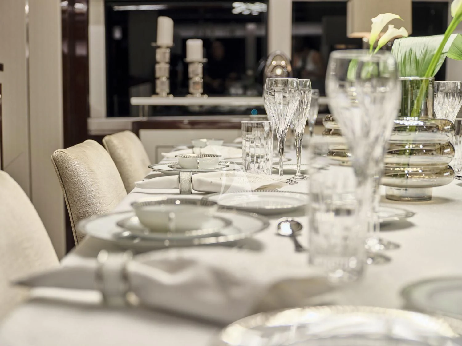 a table with plates and glasses aboard AQUA LIBRA Yacht for Charter