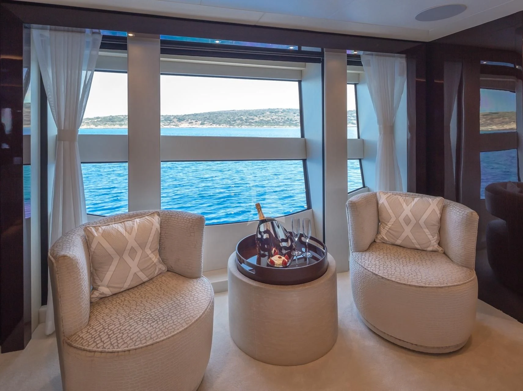 a living room with a large window aboard AQUA LIBRA Yacht for Charter