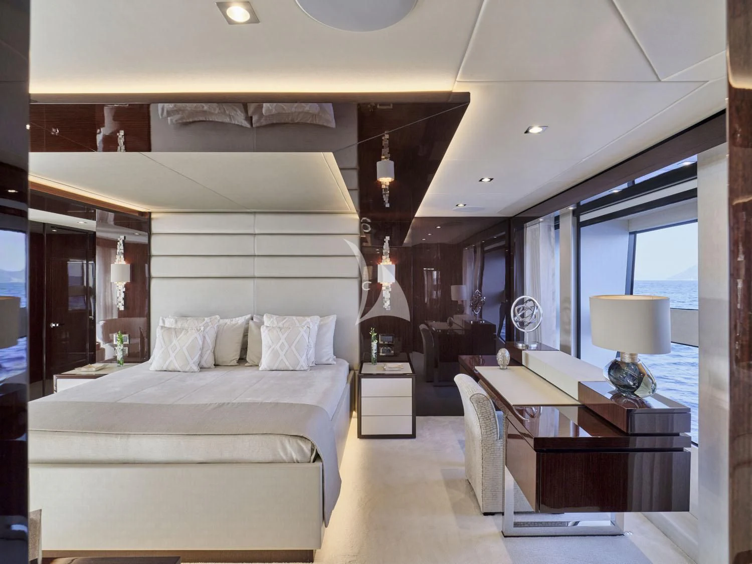 a bedroom with a bed and a desk aboard AQUA LIBRA Yacht for Charter