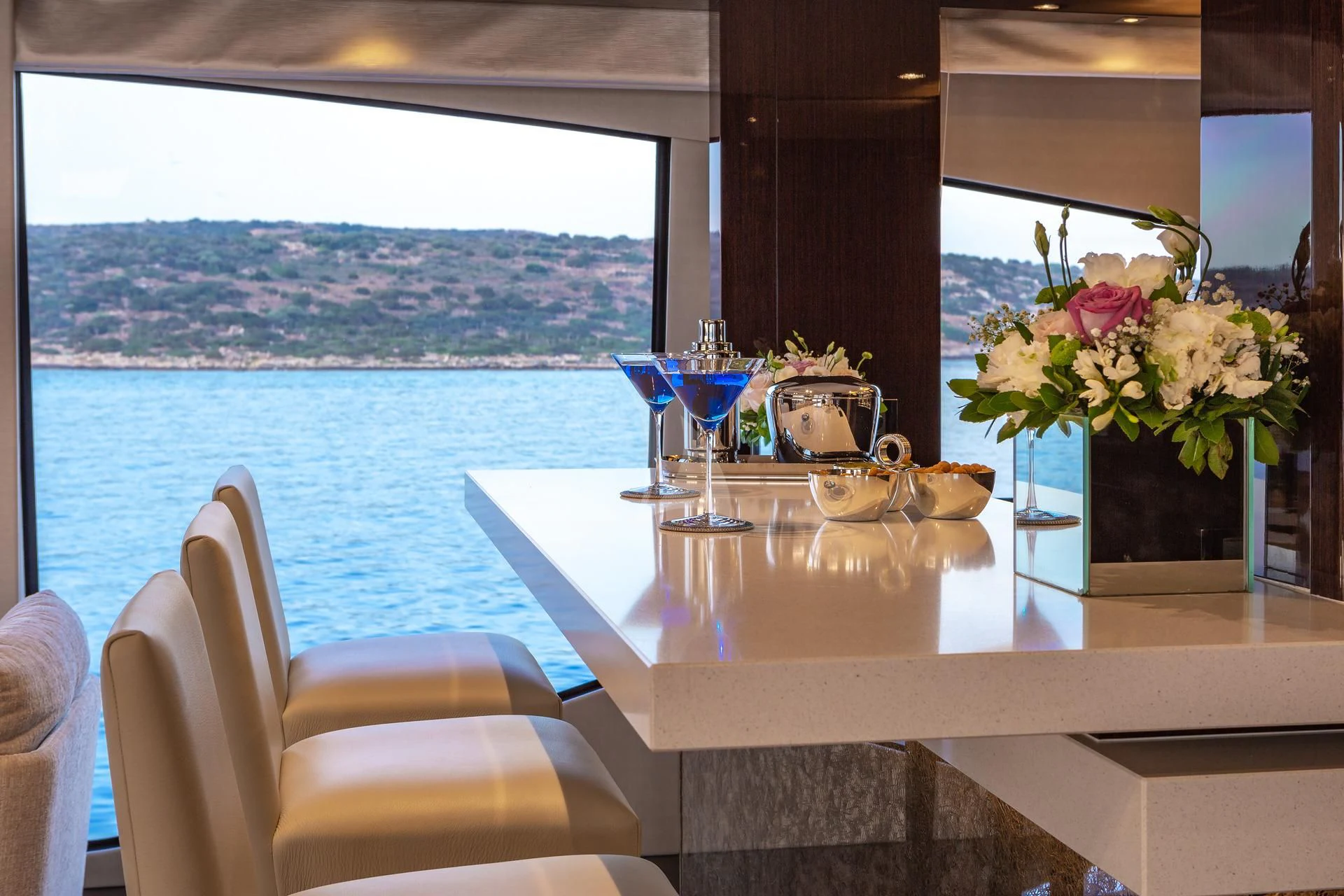 a table with glasses and flowers on it aboard AQUA LIBRA Yacht for Charter