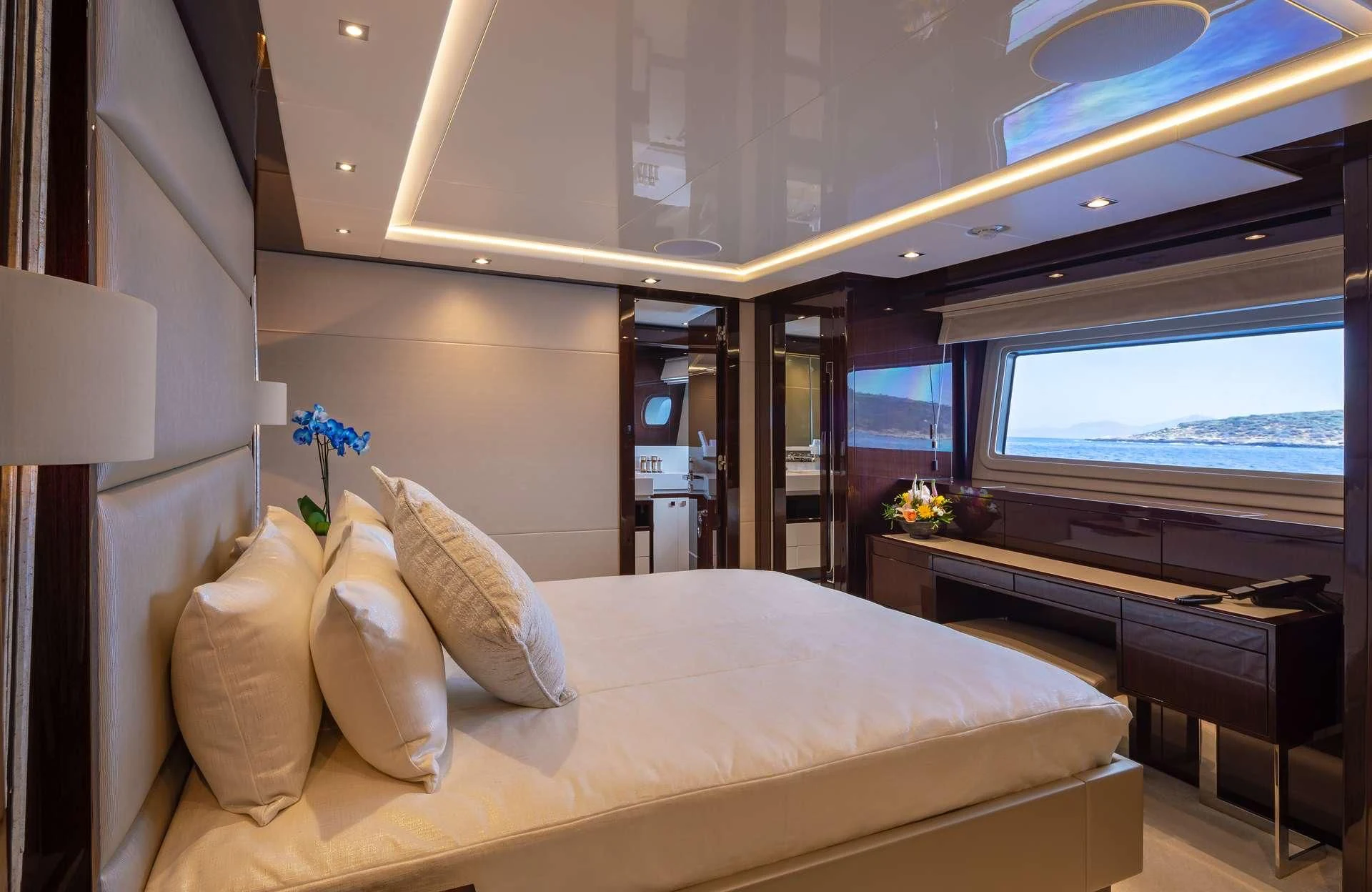 a hotel room with a bed and a desk aboard AQUA LIBRA Yacht for Charter