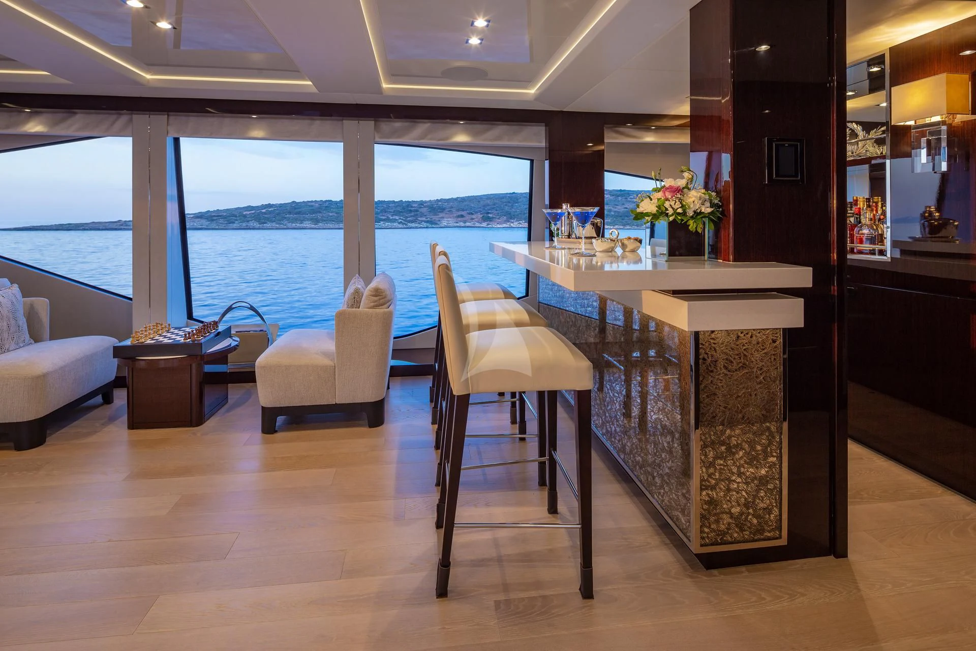 a room with a table chairs and a large window aboard AQUA LIBRA Yacht for Charter