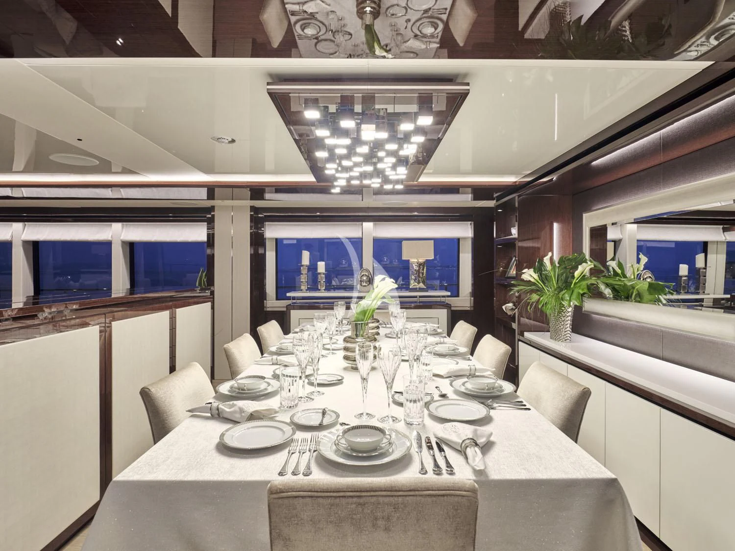 a dining room with a table set aboard AQUA LIBRA Yacht for Charter