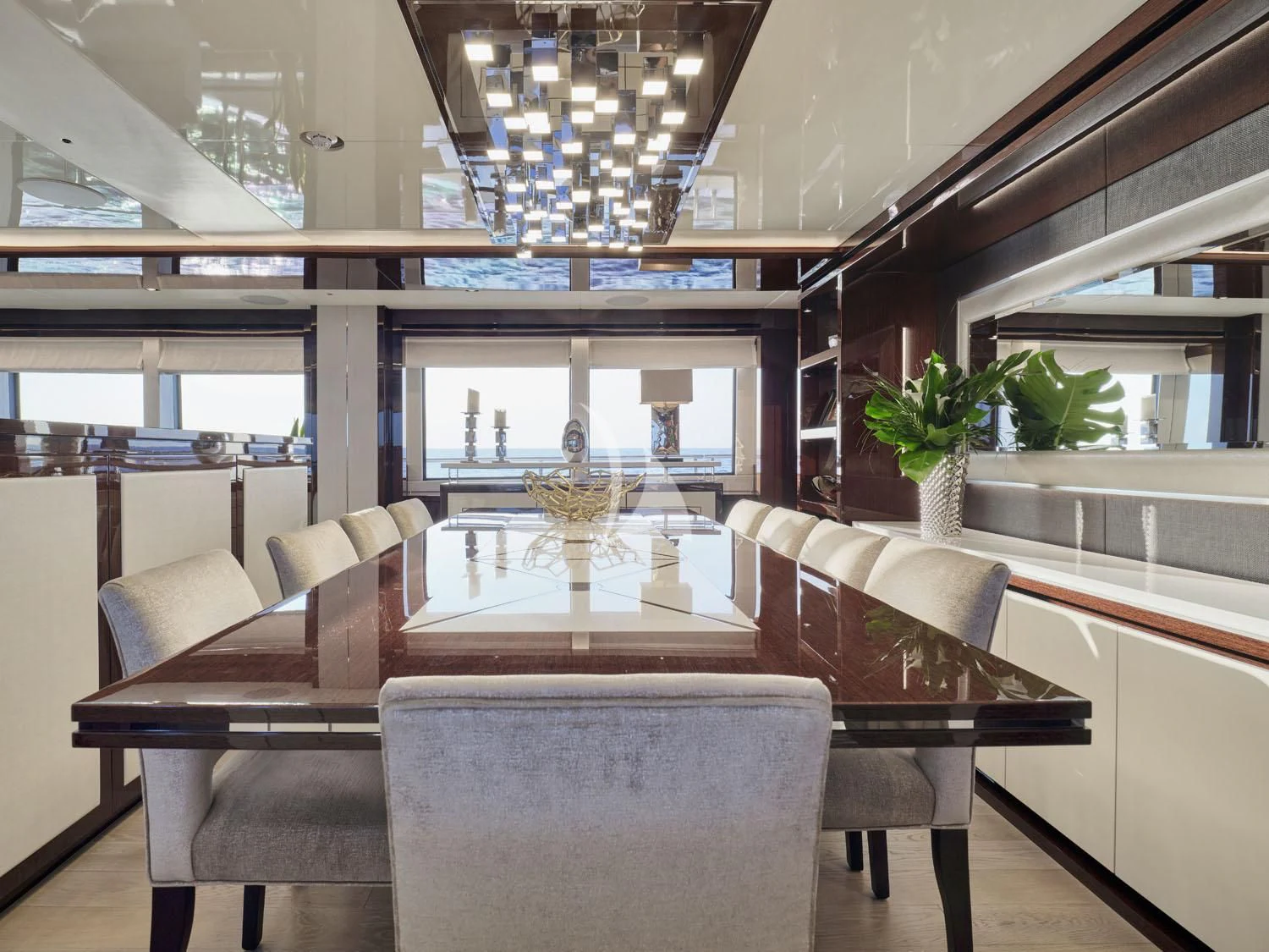 a living room with a large table and chairs aboard AQUA LIBRA Yacht for Charter