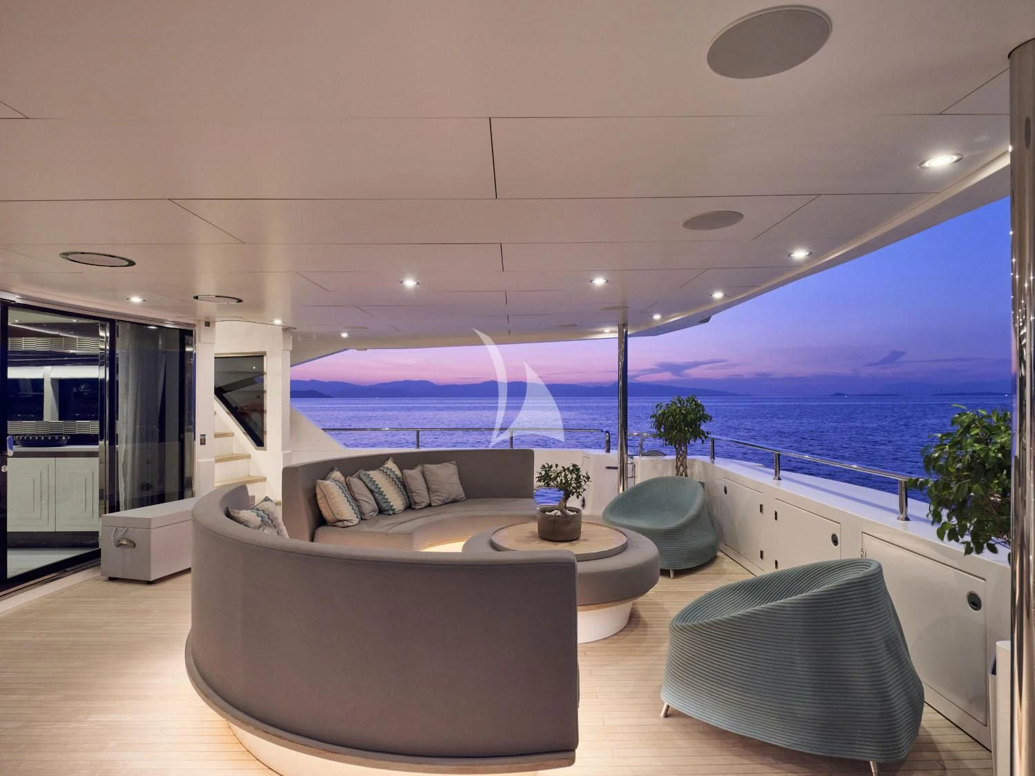 a large living room with a large balcony overlooking the ocean aboard AQUA LIBRA Yacht for Charter