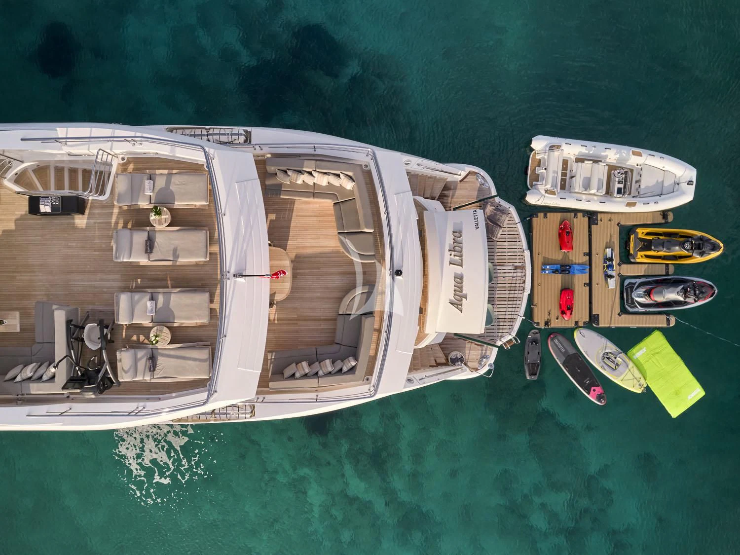 a large ship with several small boats aboard AQUA LIBRA Yacht for Charter