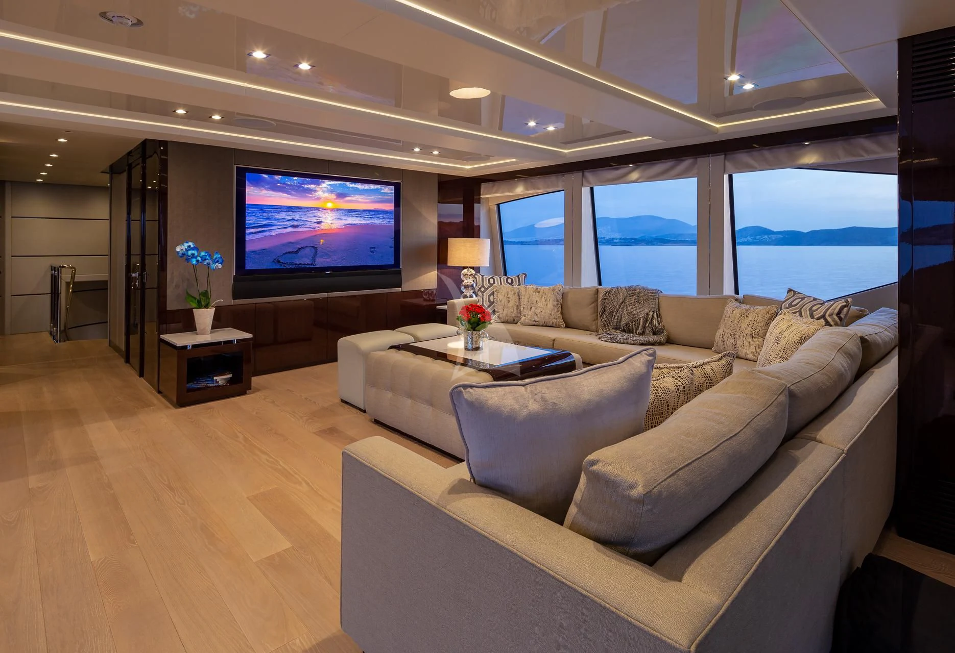 a living room with a large screen aboard AQUA LIBRA Yacht for Charter
