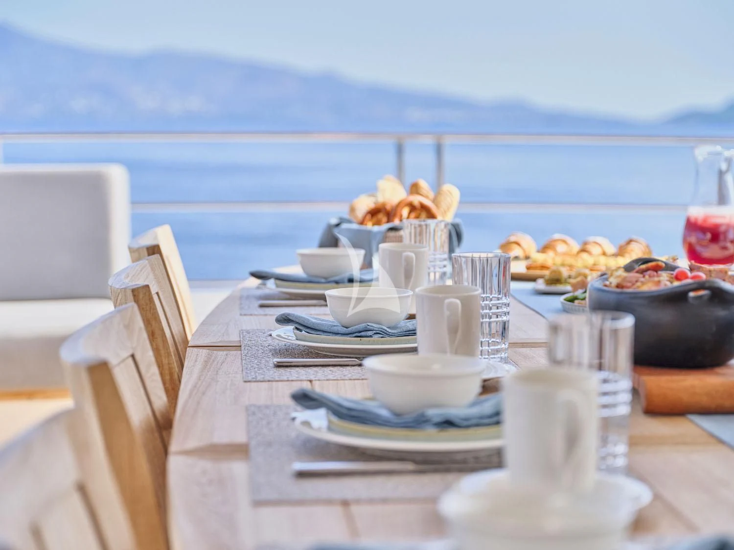 a table with plates and cups on it aboard AQUA LIBRA Yacht for Charter
