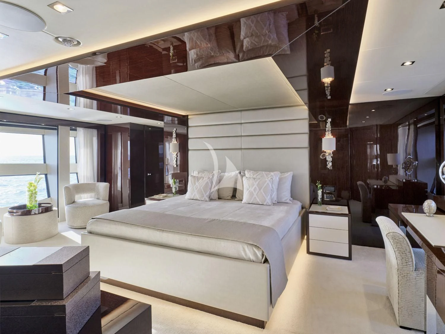 a bedroom with a bed and a chair aboard AQUA LIBRA Yacht for Charter