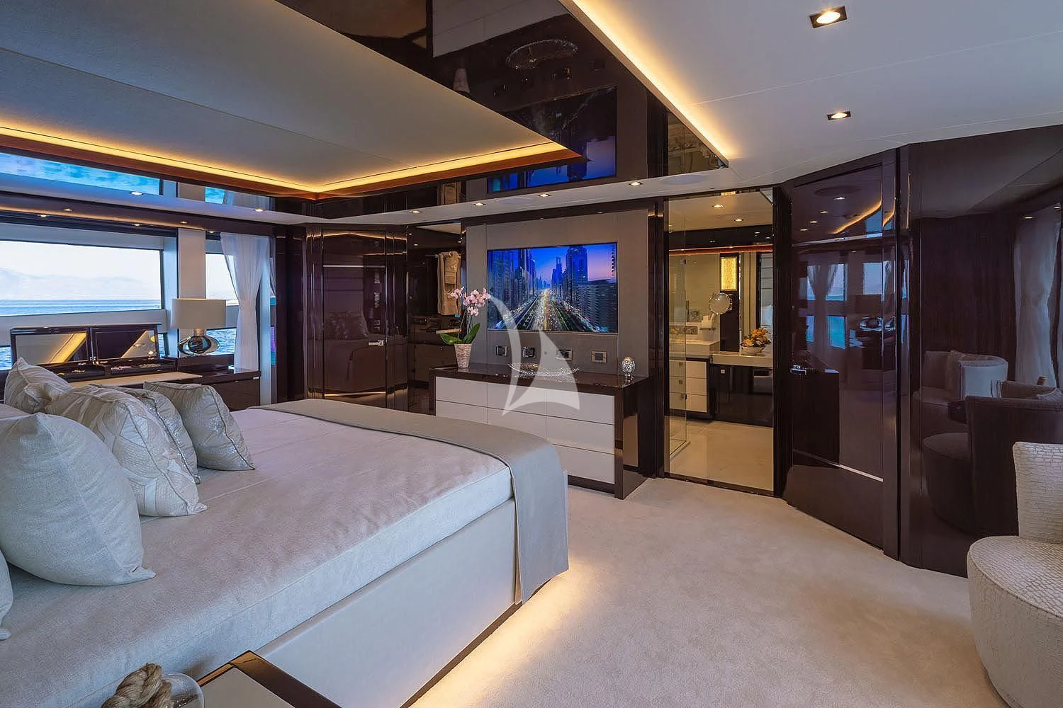 a bedroom with a bed and a tv aboard AQUA LIBRA Yacht for Charter