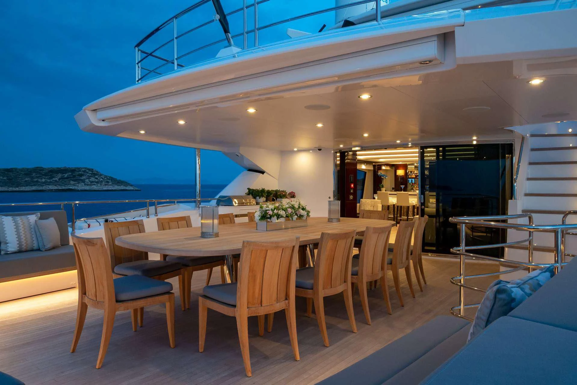 a table and chairs on a deck aboard AQUA LIBRA Yacht for Charter