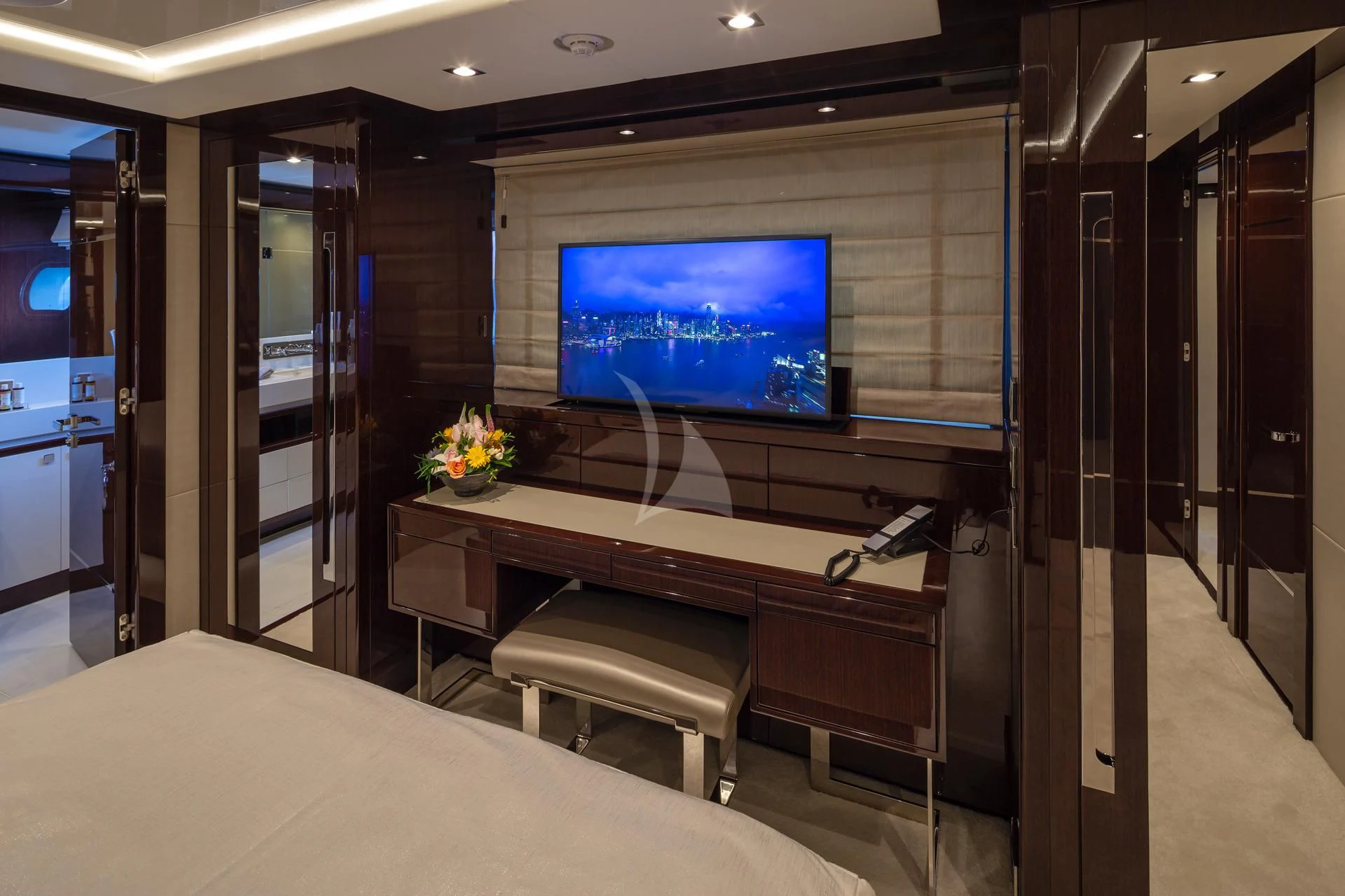 a room with a tv and desk aboard AQUA LIBRA Yacht for Charter