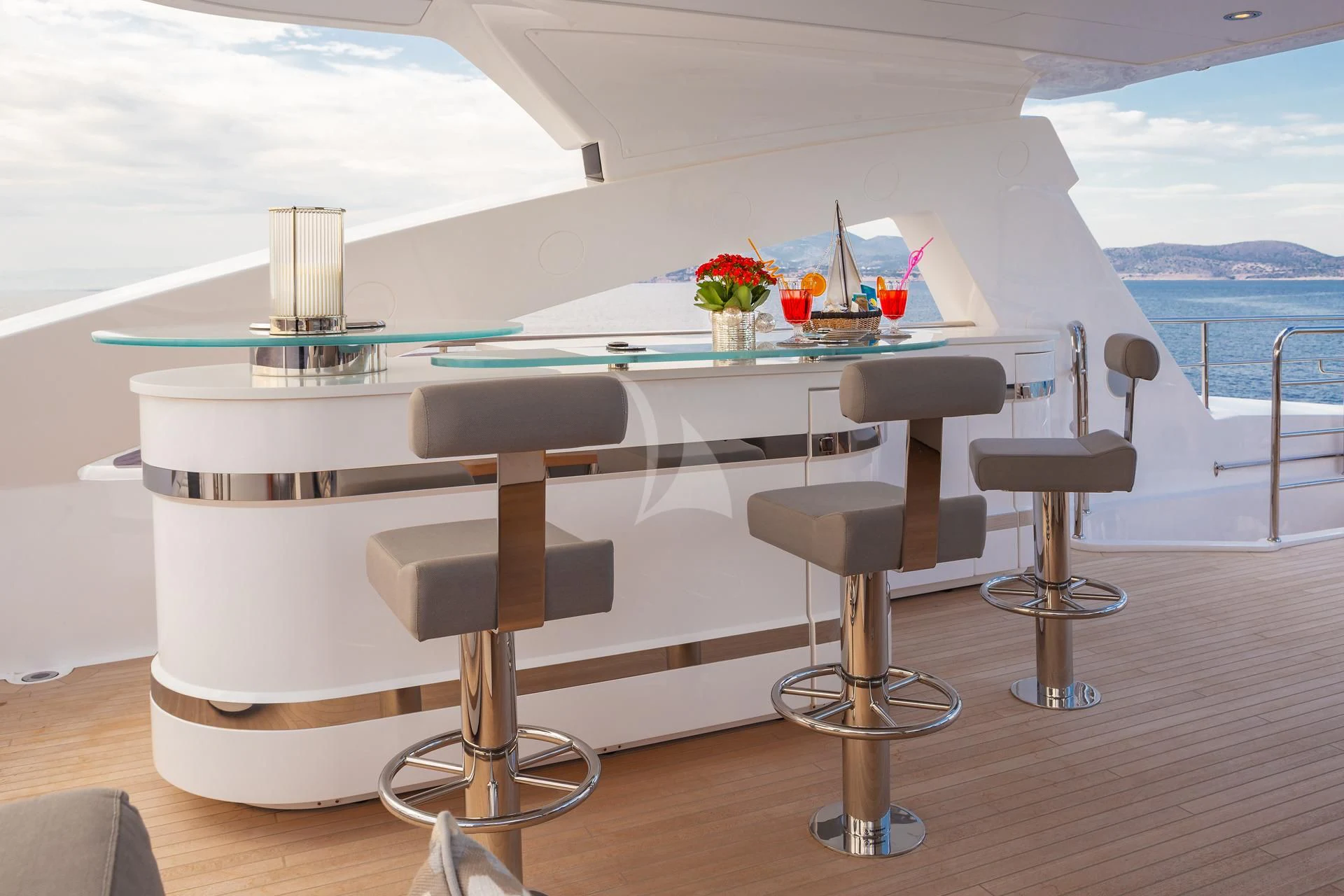 a table with chairs and stools on it aboard AQUA LIBRA Yacht for Charter