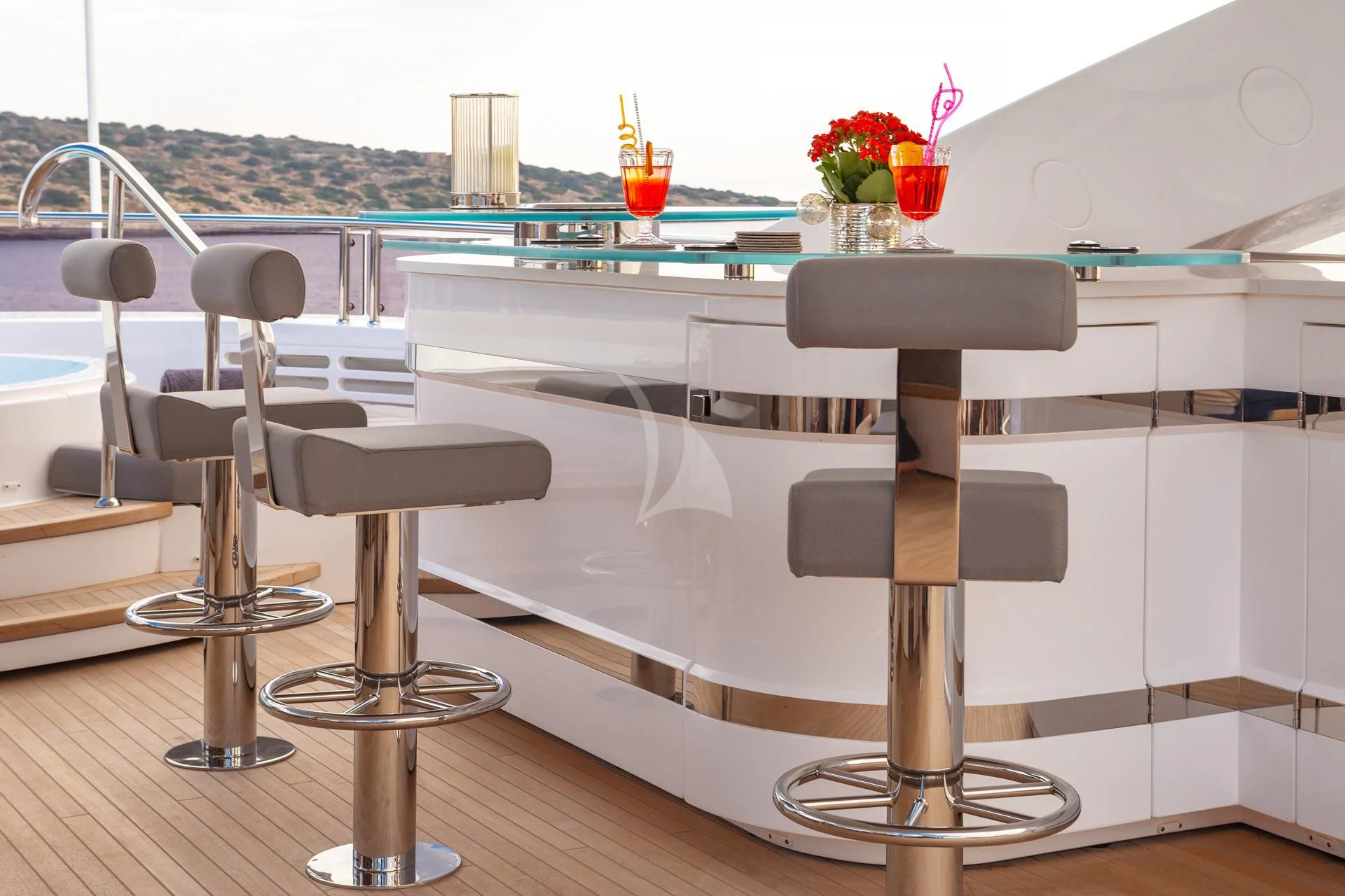 a table with chairs and a glass window aboard AQUA LIBRA Yacht for Charter
