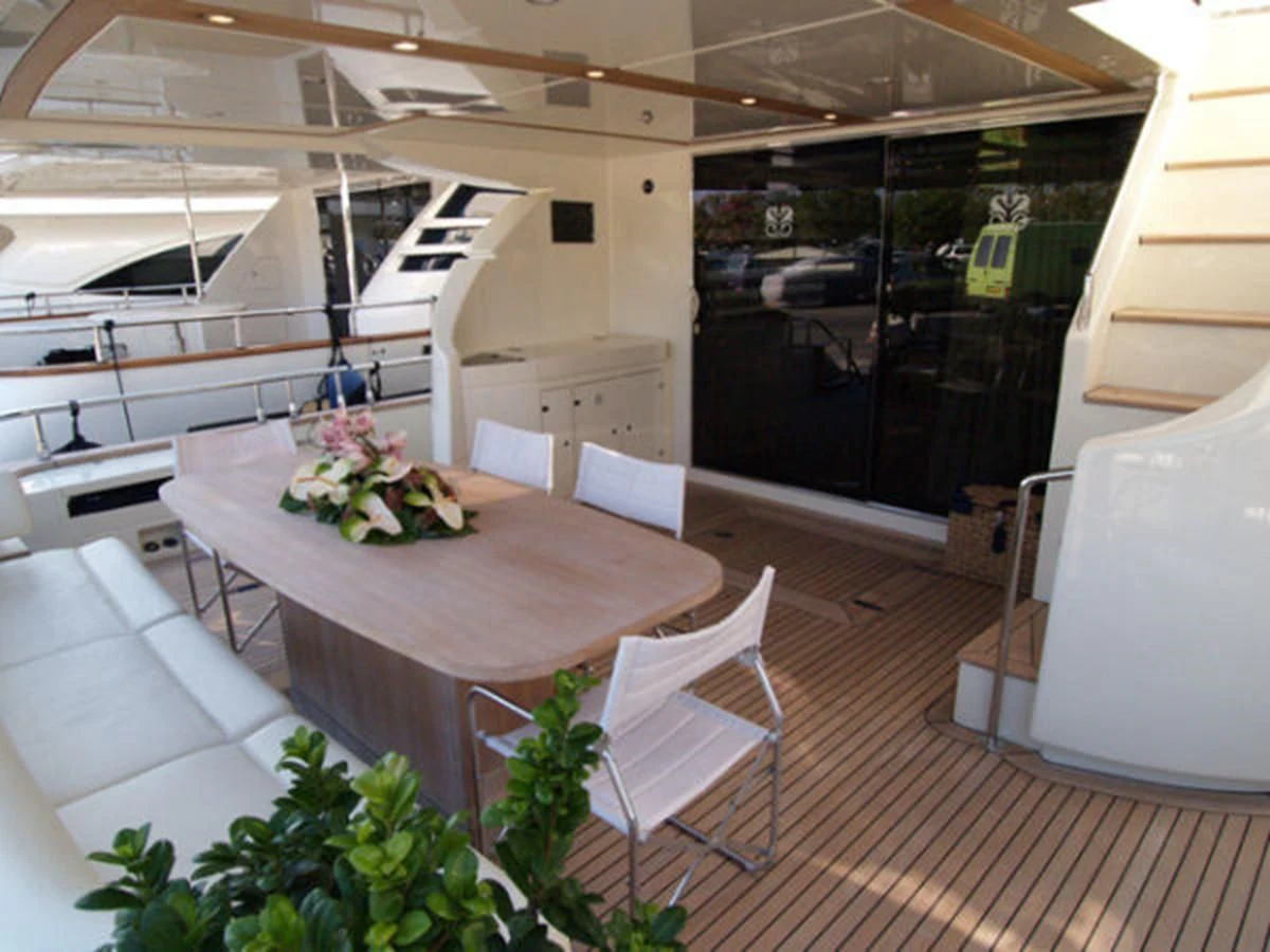 a table and chairs in a room aboard ADEL I Yacht for Sale