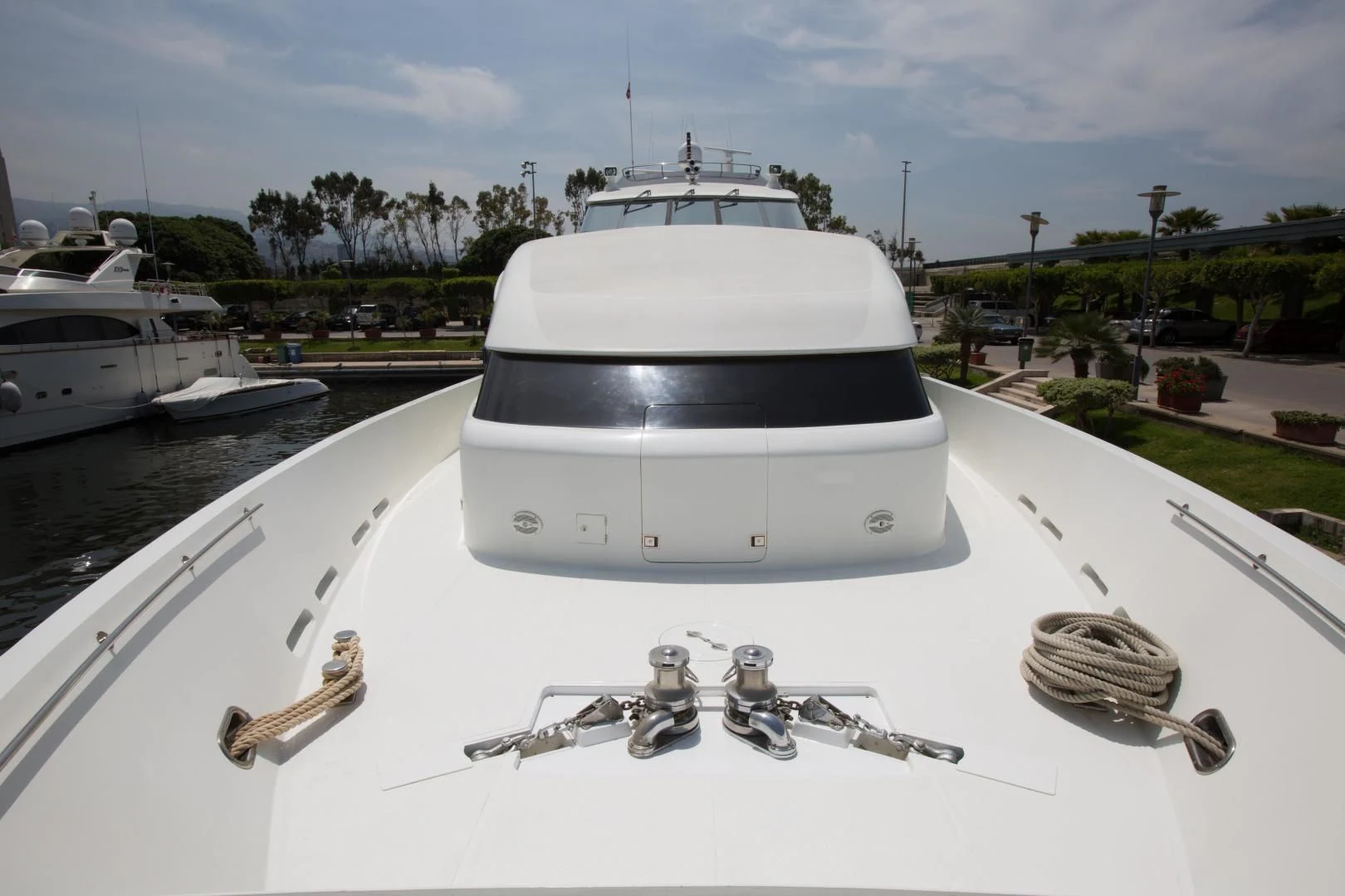 a white yacht in a harbor aboard TAMTEEN Yacht for Sale