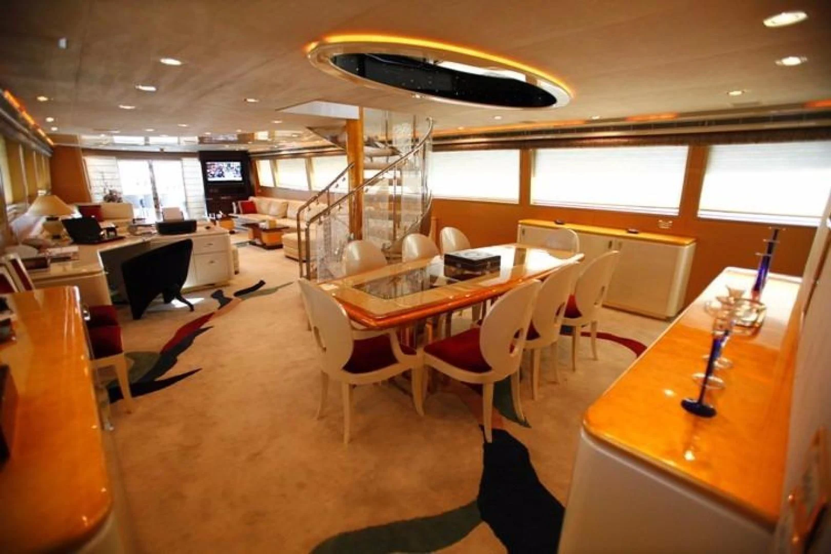 a room with tables and chairs aboard TAMTEEN Yacht for Sale