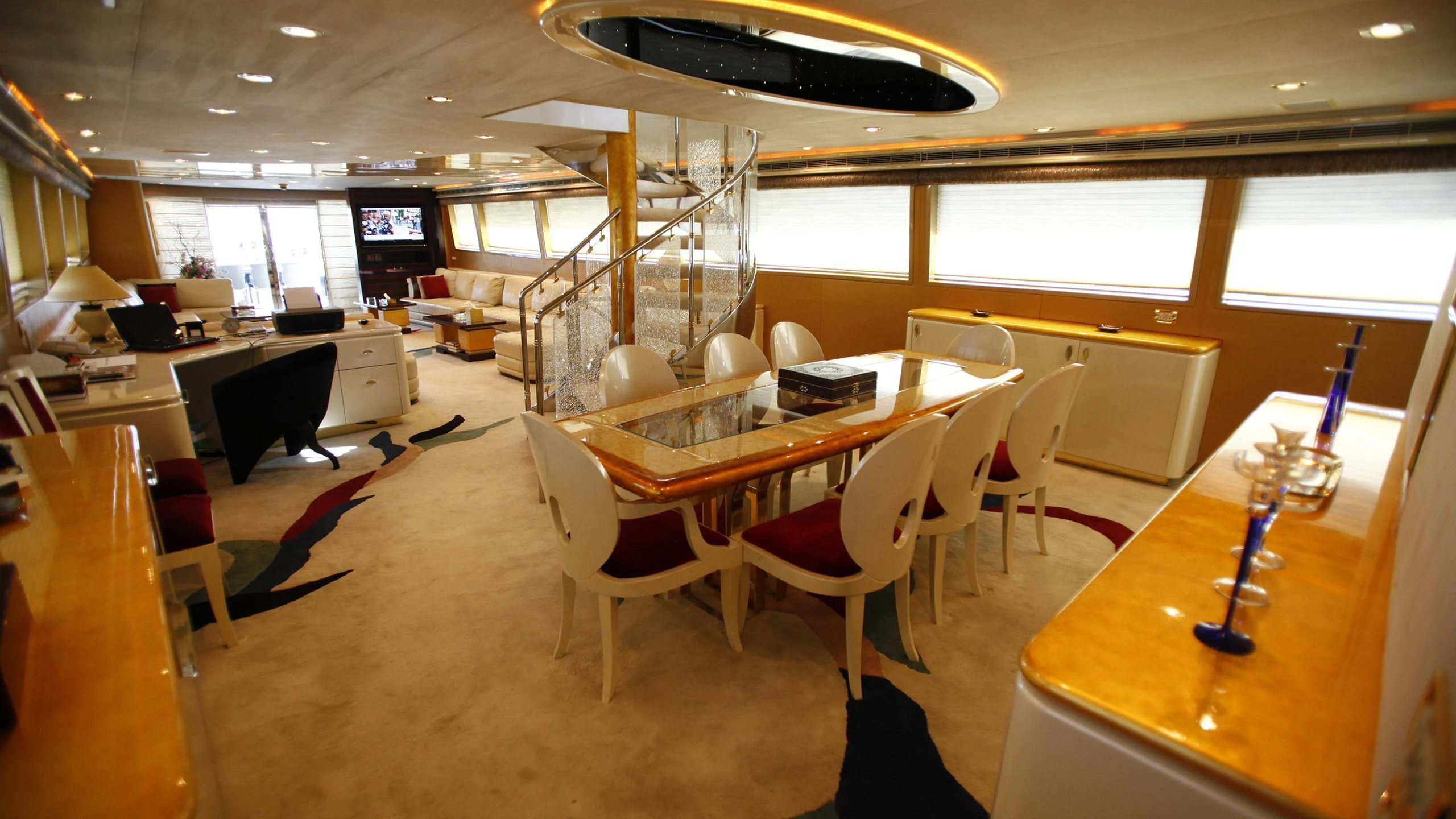 a room with tables and chairs aboard TAMTEEN Yacht for Sale