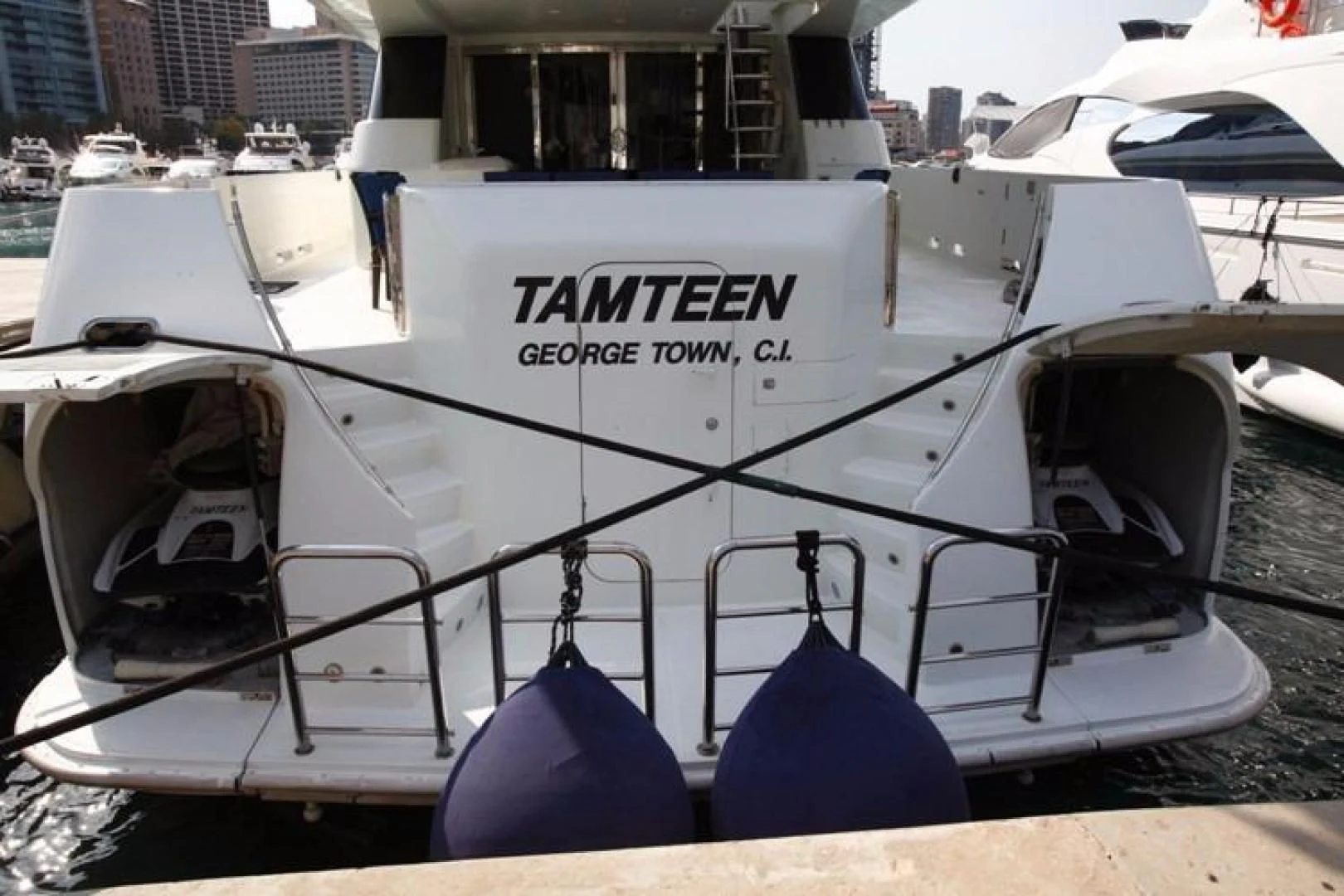 a white boat with blue chairs aboard TAMTEEN Yacht for Sale