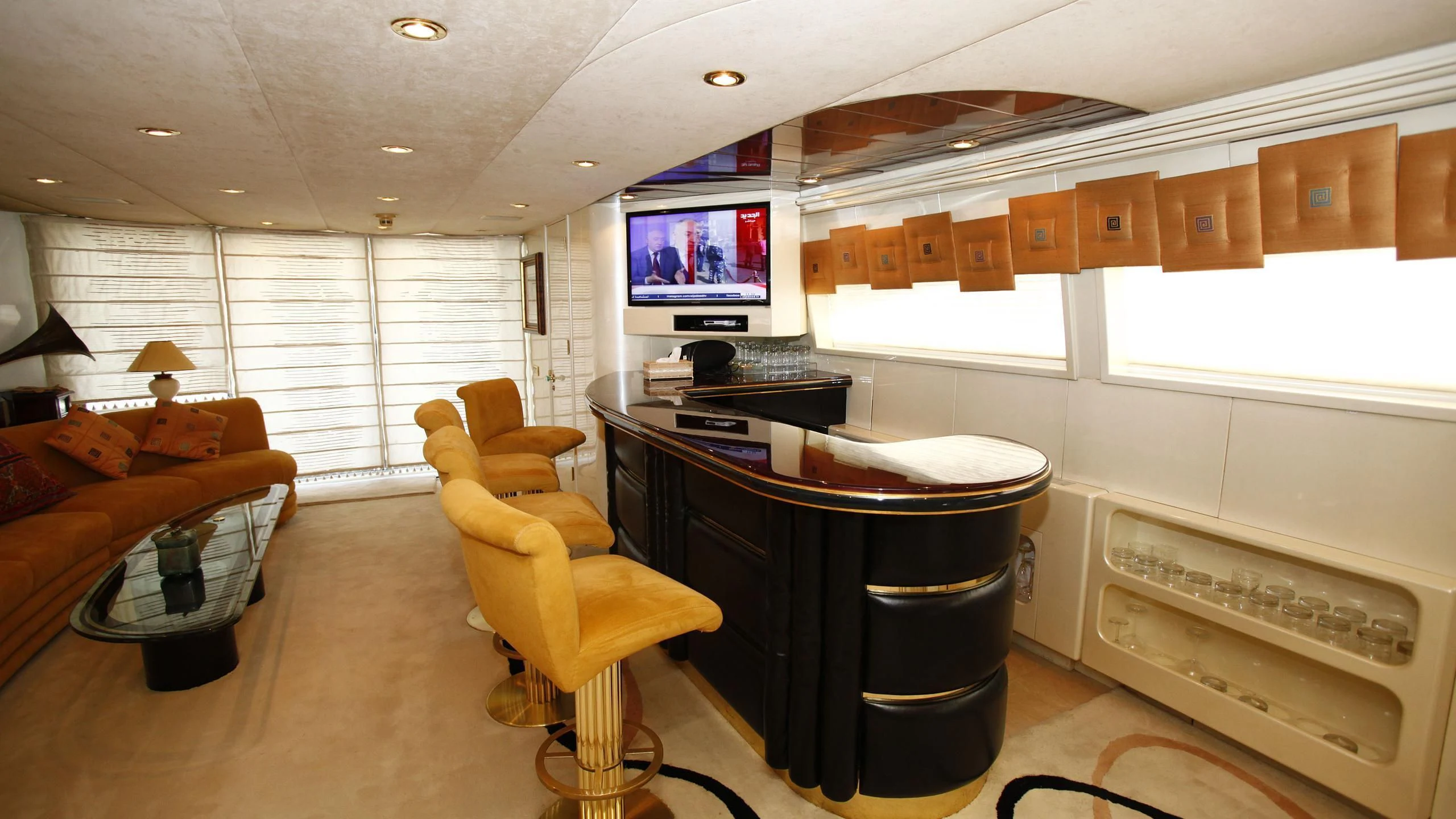 a large kitchen with a bar and a bar table aboard TAMTEEN Yacht for Sale