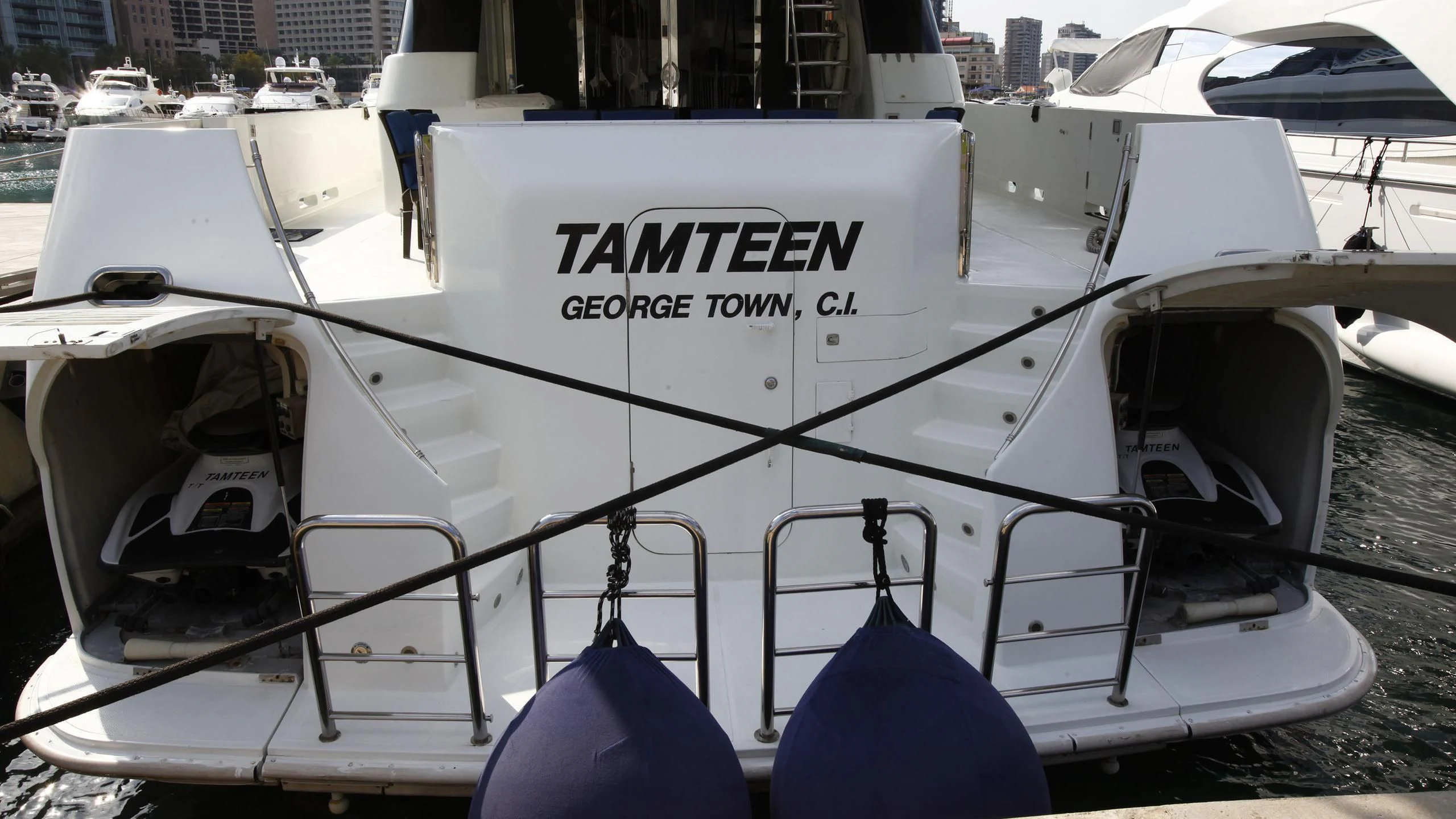a white boat with a blue seat aboard TAMTEEN Yacht for Sale