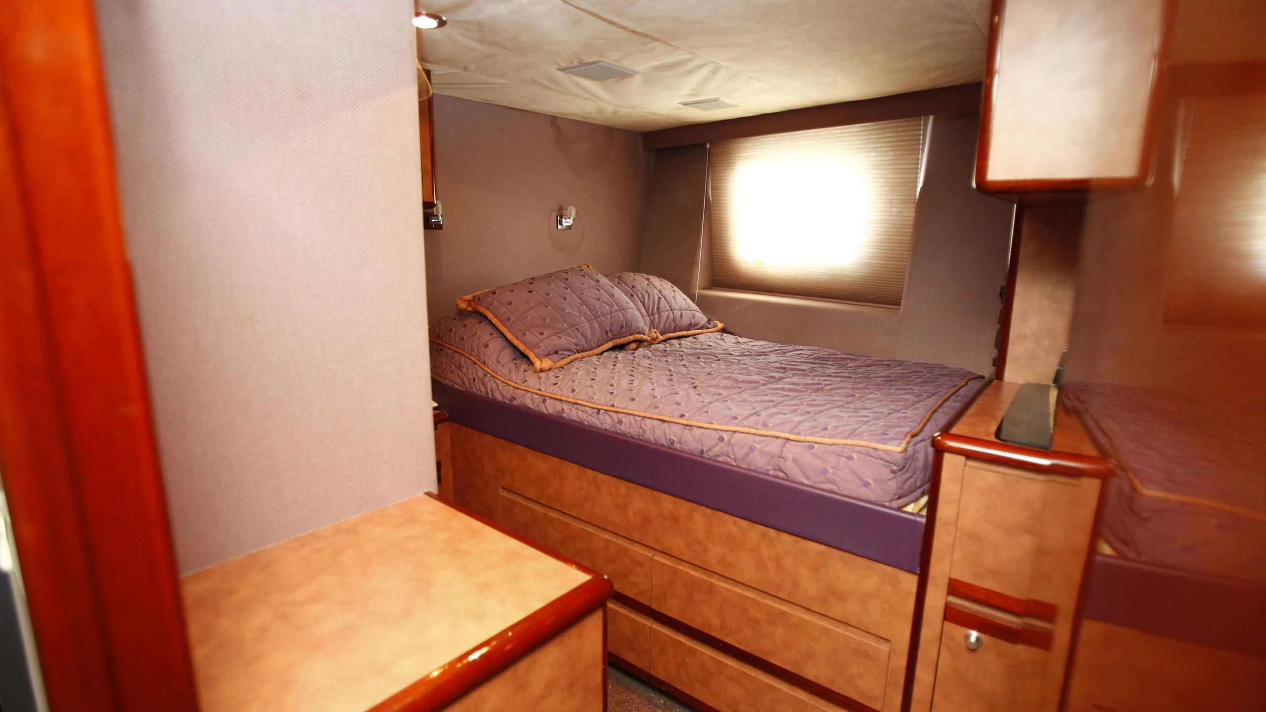 a bed with a red curtain aboard TAMTEEN Yacht for Sale