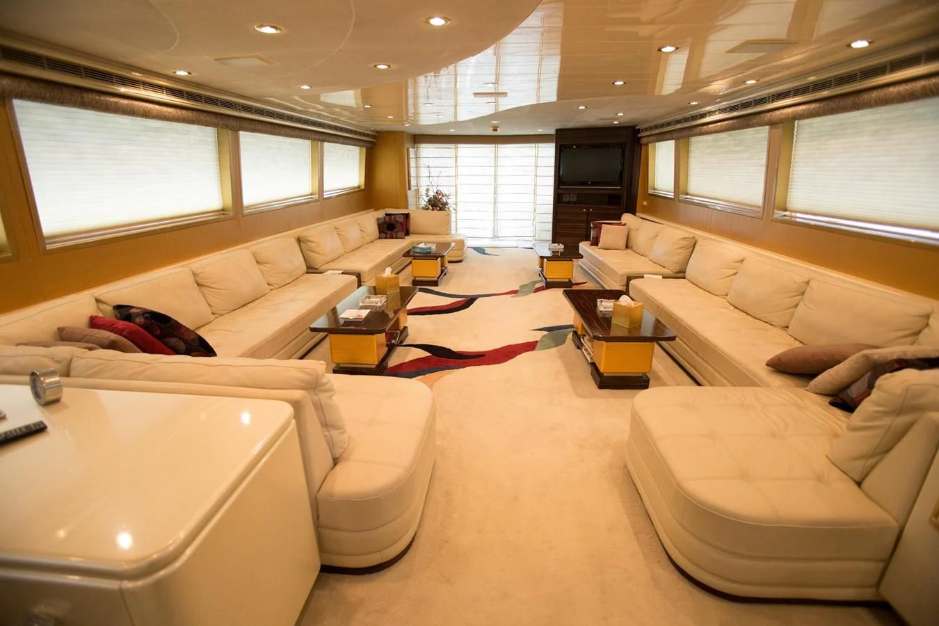 a living room with white couches aboard TAMTEEN Yacht for Sale