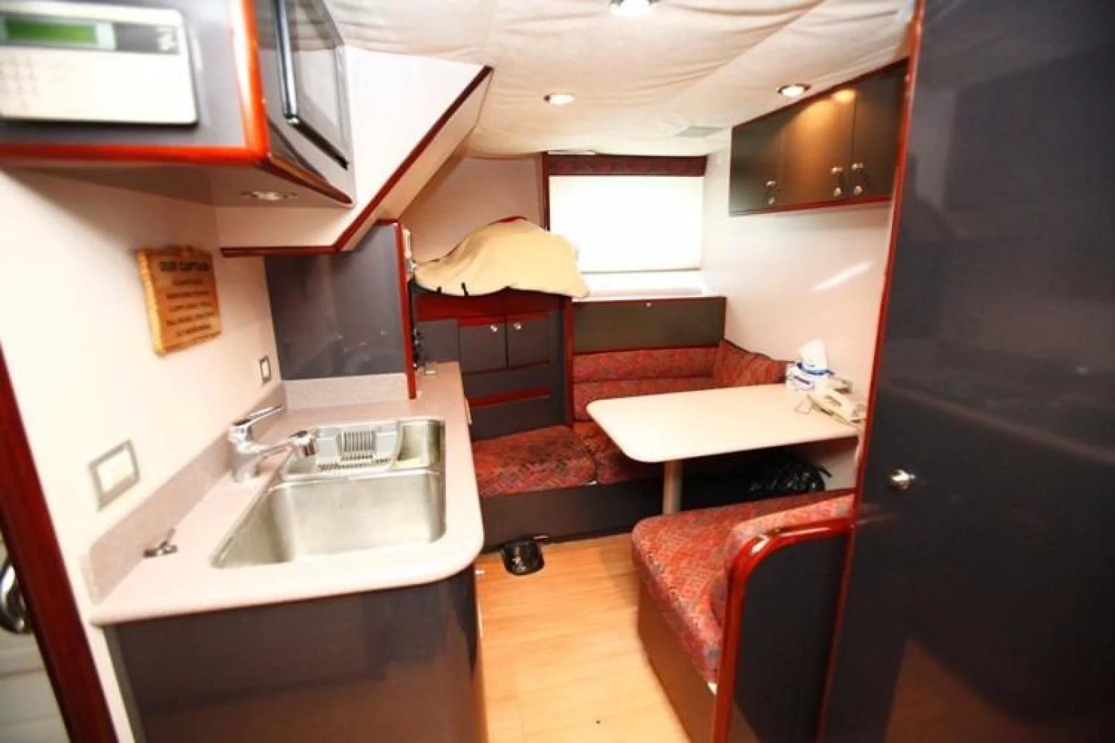 a small kitchen with a couch aboard TAMTEEN Yacht for Sale