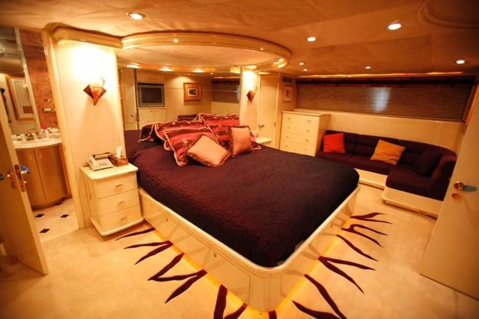 a large bedroom with a bed and a couch aboard TAMTEEN Yacht for Sale