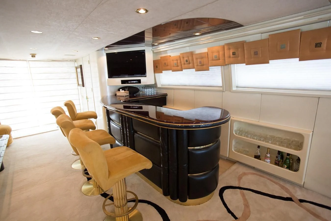 a kitchen with a bar and a bar stool aboard TAMTEEN Yacht for Sale