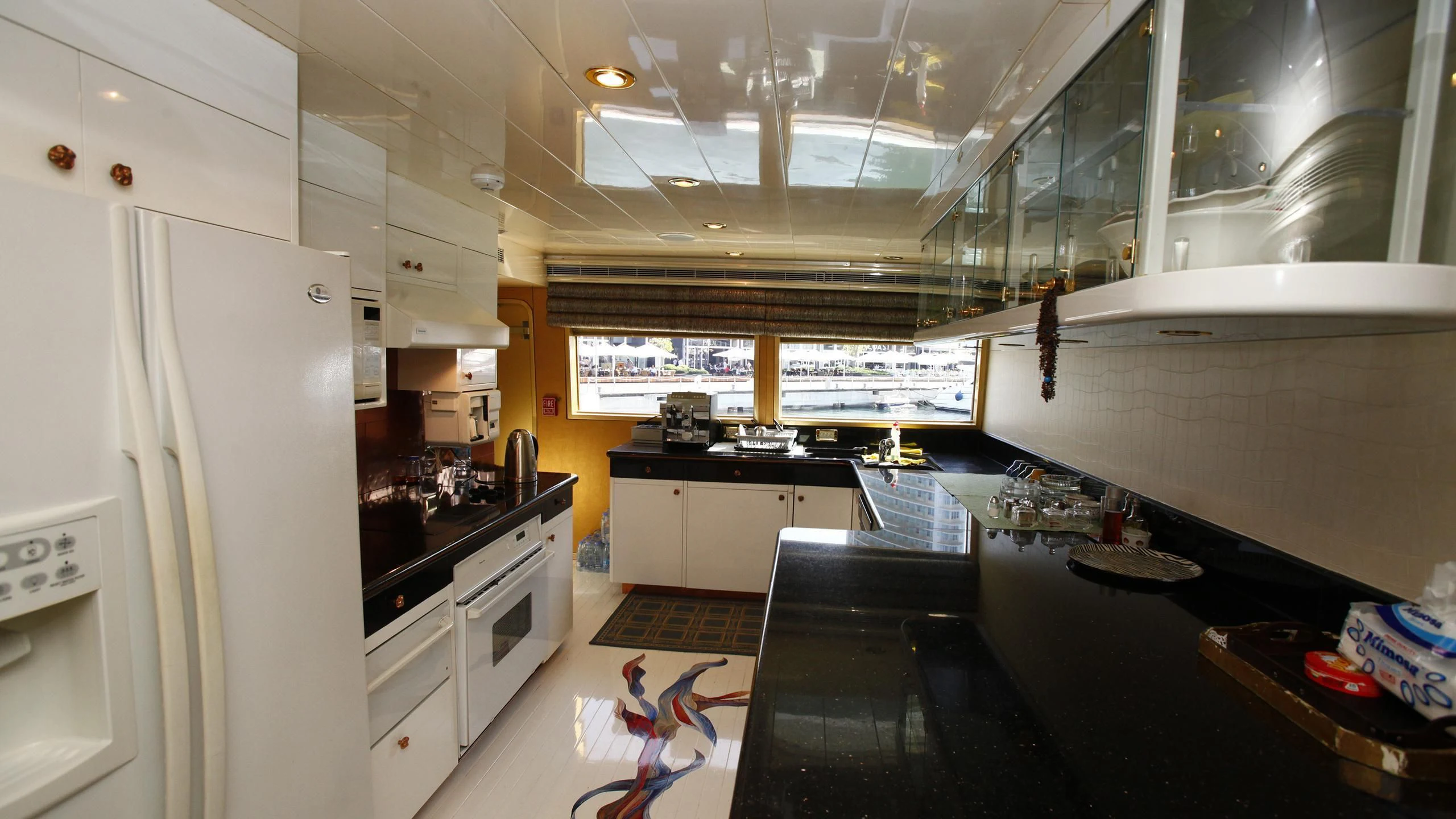 a kitchen with white cabinets aboard TAMTEEN Yacht for Sale