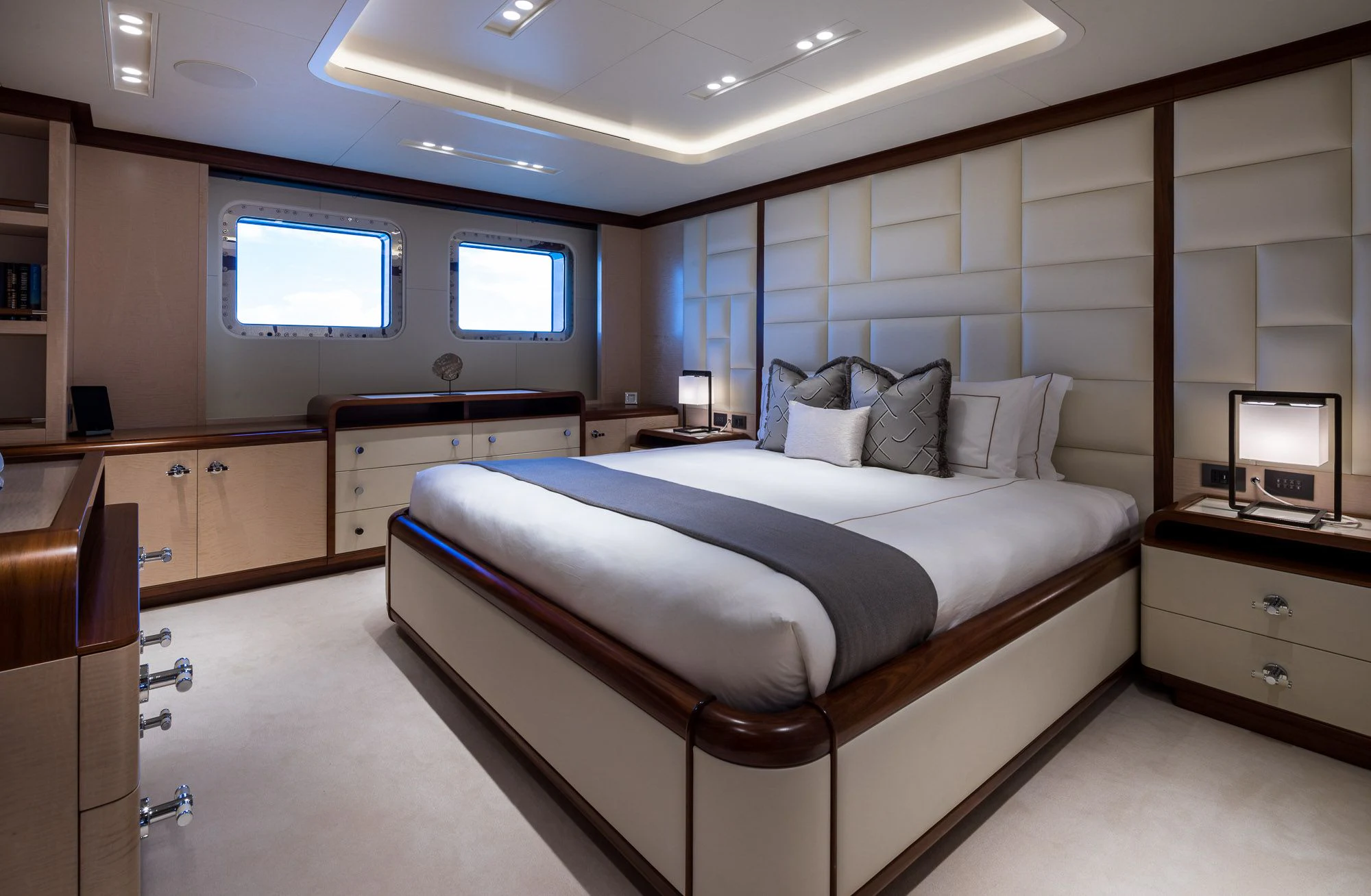 a bedroom with a bed and desk aboard CALEX Yacht for Sale