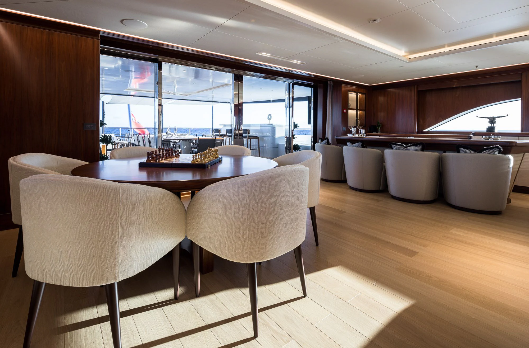 a room with a table and chairs aboard CALEX Yacht for Sale