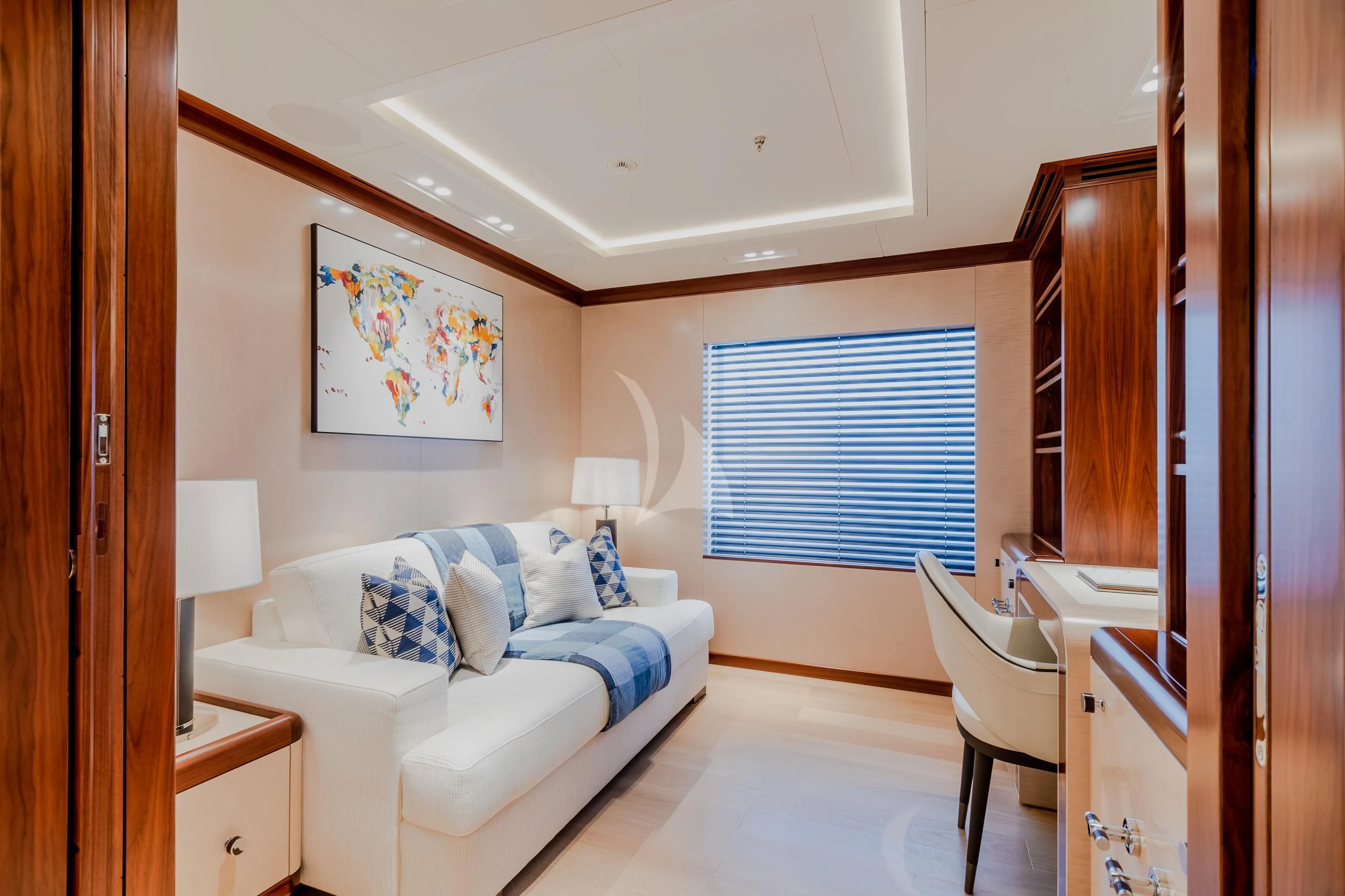 a bedroom with a bed and a chair aboard CALEX Yacht for Sale