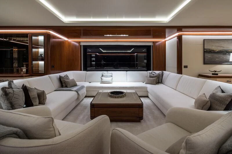 a living room with white couches aboard CALEX Yacht for Sale
