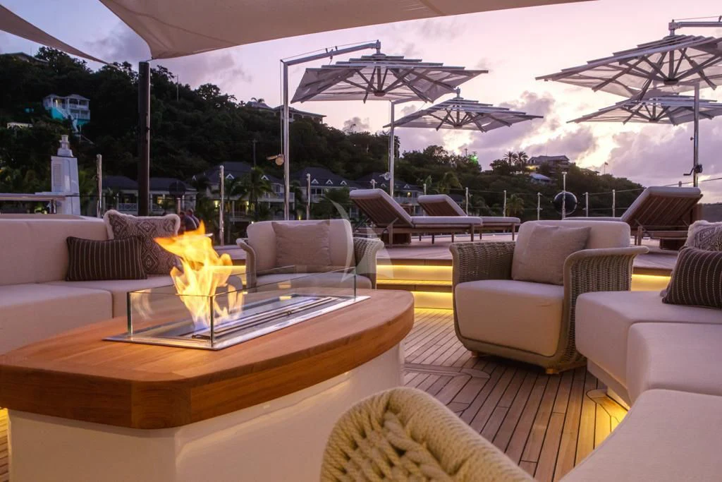 a living room with a table and chairs aboard CALEX Yacht for Sale