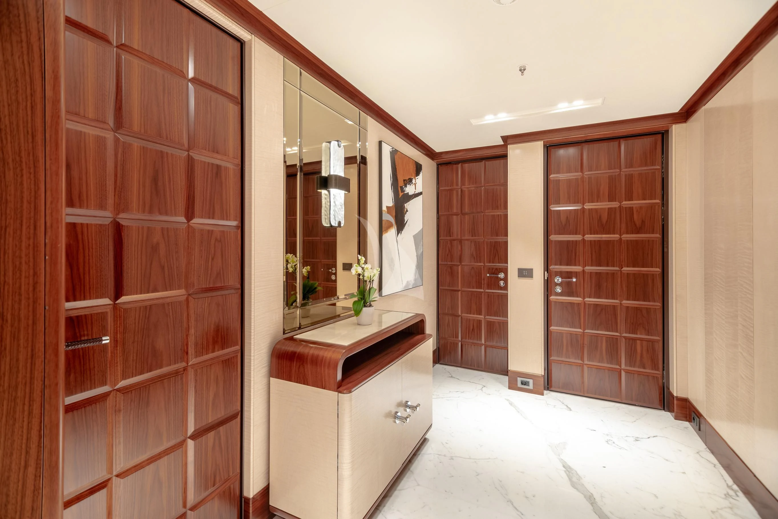 a room with a mirror and cabinets aboard CALEX Yacht for Sale