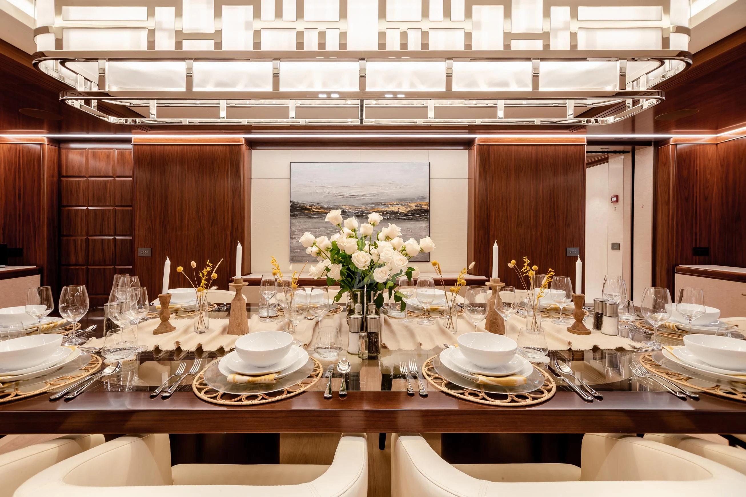 a table set with plates and silverware aboard CALEX Yacht for Sale