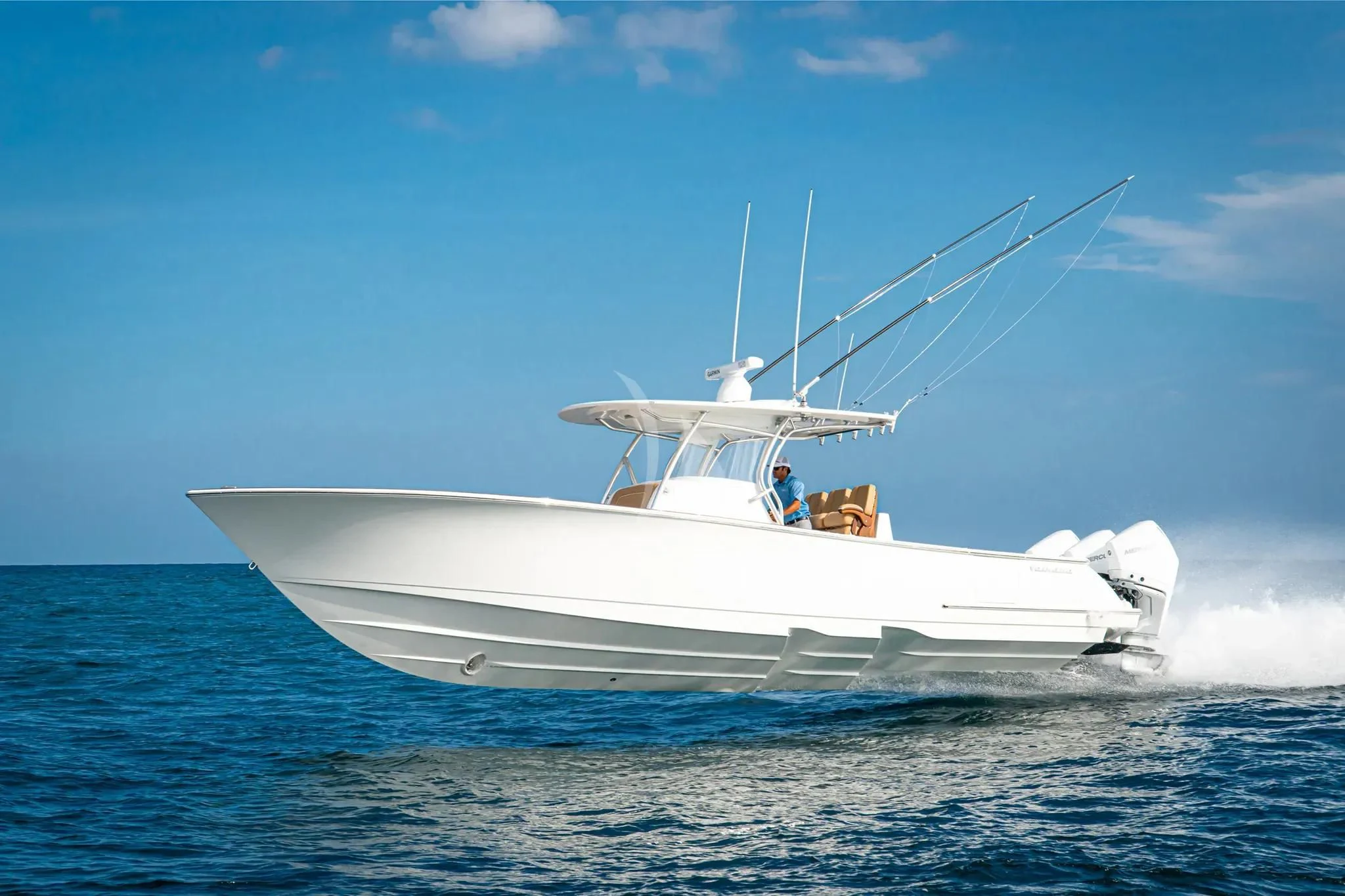 a white boat with a couple people on it in the water aboard CALEX Yacht for Sale