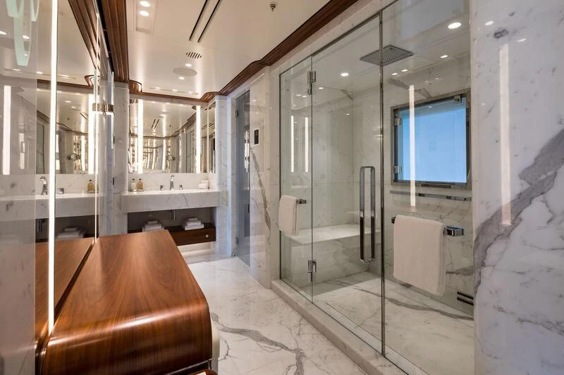 a bathroom with a glass shower aboard CALEX Yacht for Sale