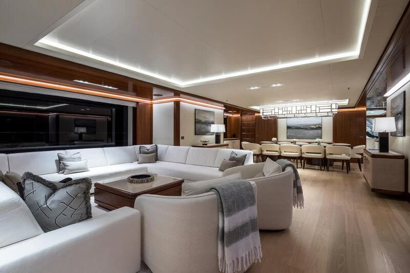 a living room with a large sofa aboard CALEX Yacht for Sale