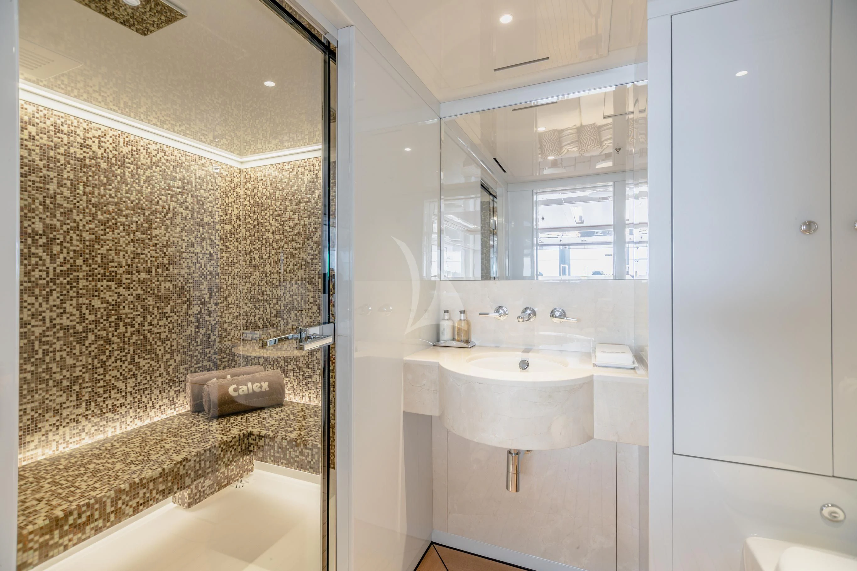 a bathroom with a sink and a mirror aboard CALEX Yacht for Sale